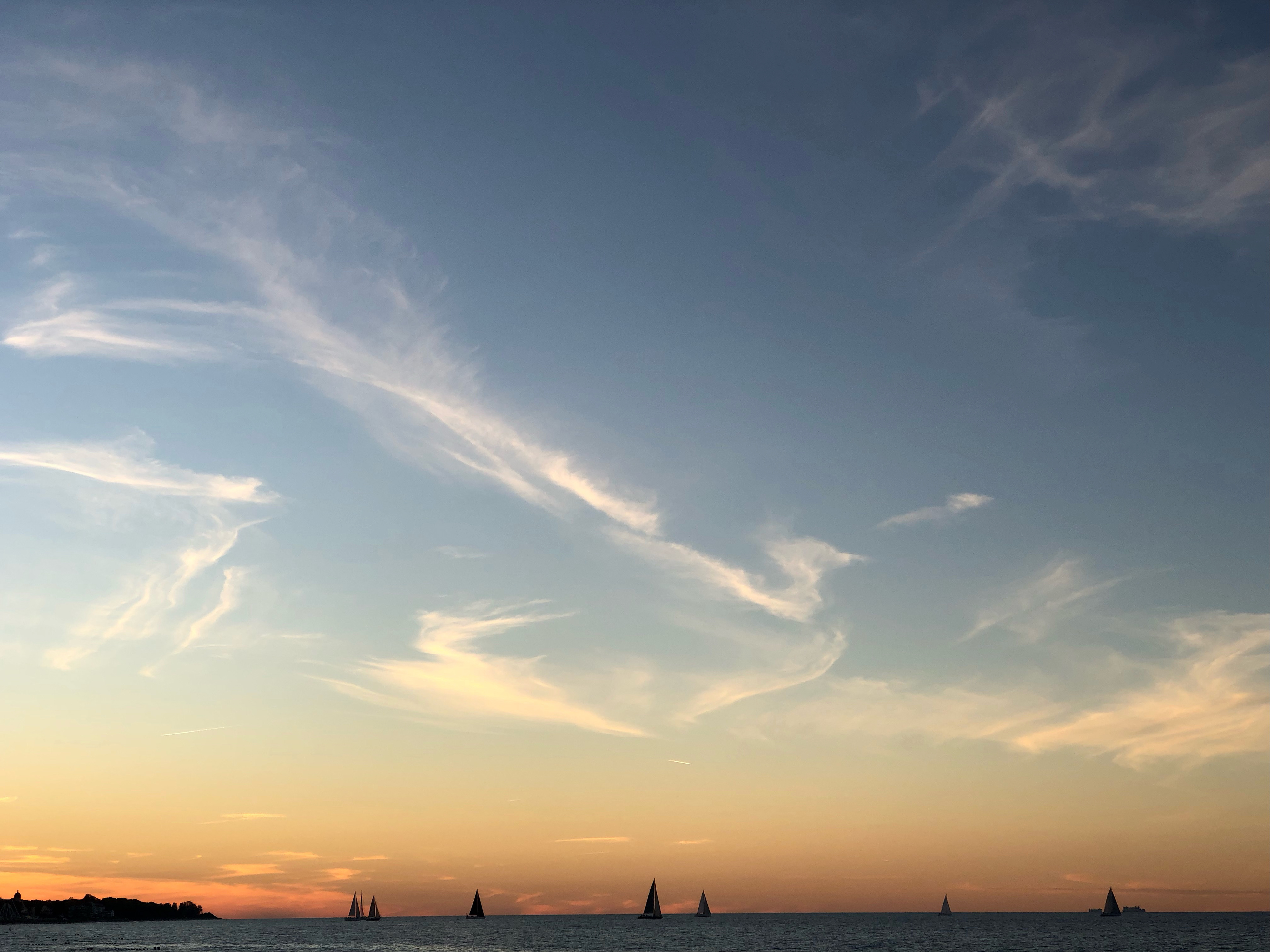 sunset over the Baltic sea near Kühlungsborn, with sailing boats on the horizon