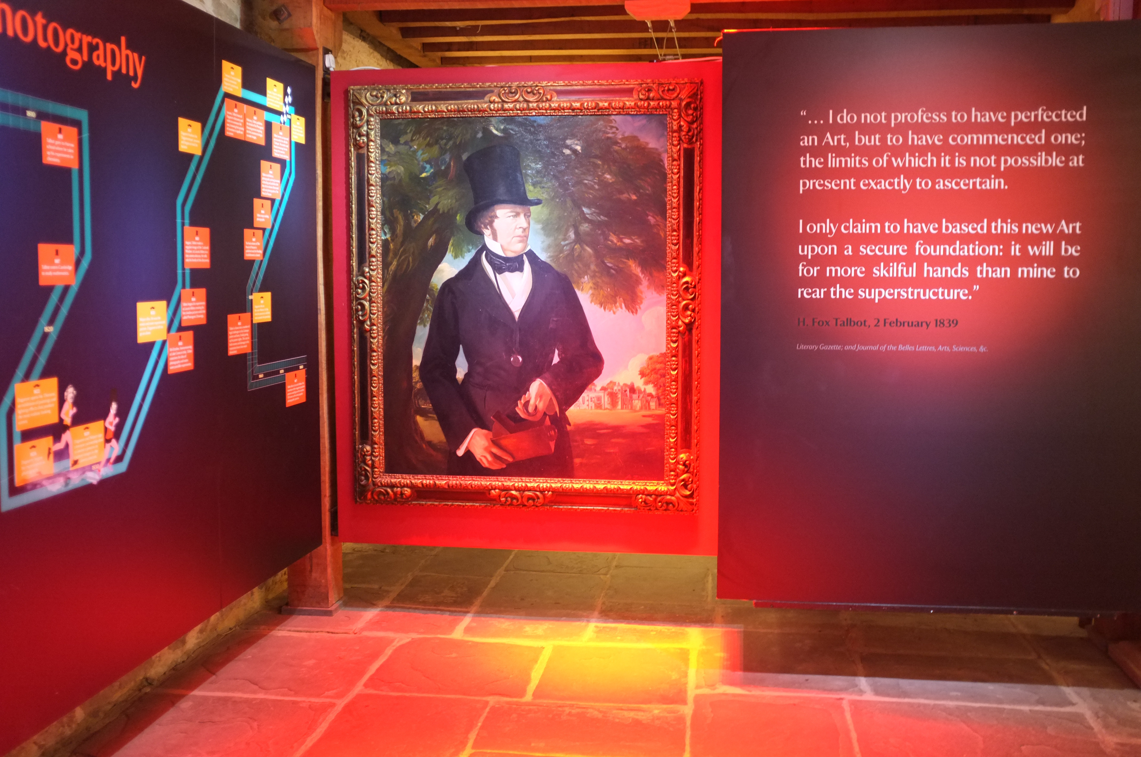 image of Henry Fox Talbot in the museum at Lacock Abbey. Next to it, a quote in large text: "... I do not profess to have perfected an Art, but to have commenced one; the limits of which it is not possible at present exactly to ascertain. I only claim to have based this new Art upon a secure foundatioin: it will be for more skilful hands than mine to rear the superstructure."