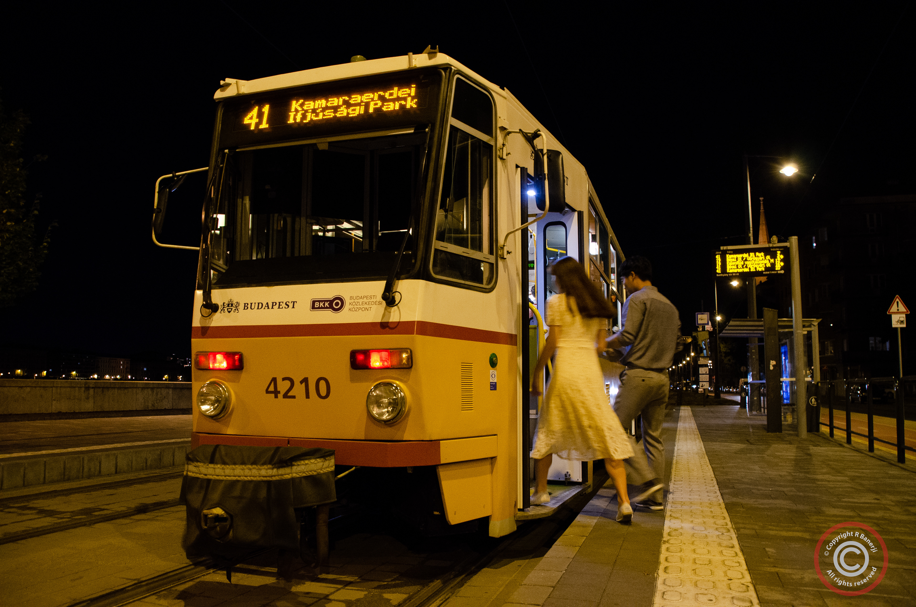 Jumping on a night tram, Budapest, Hungary