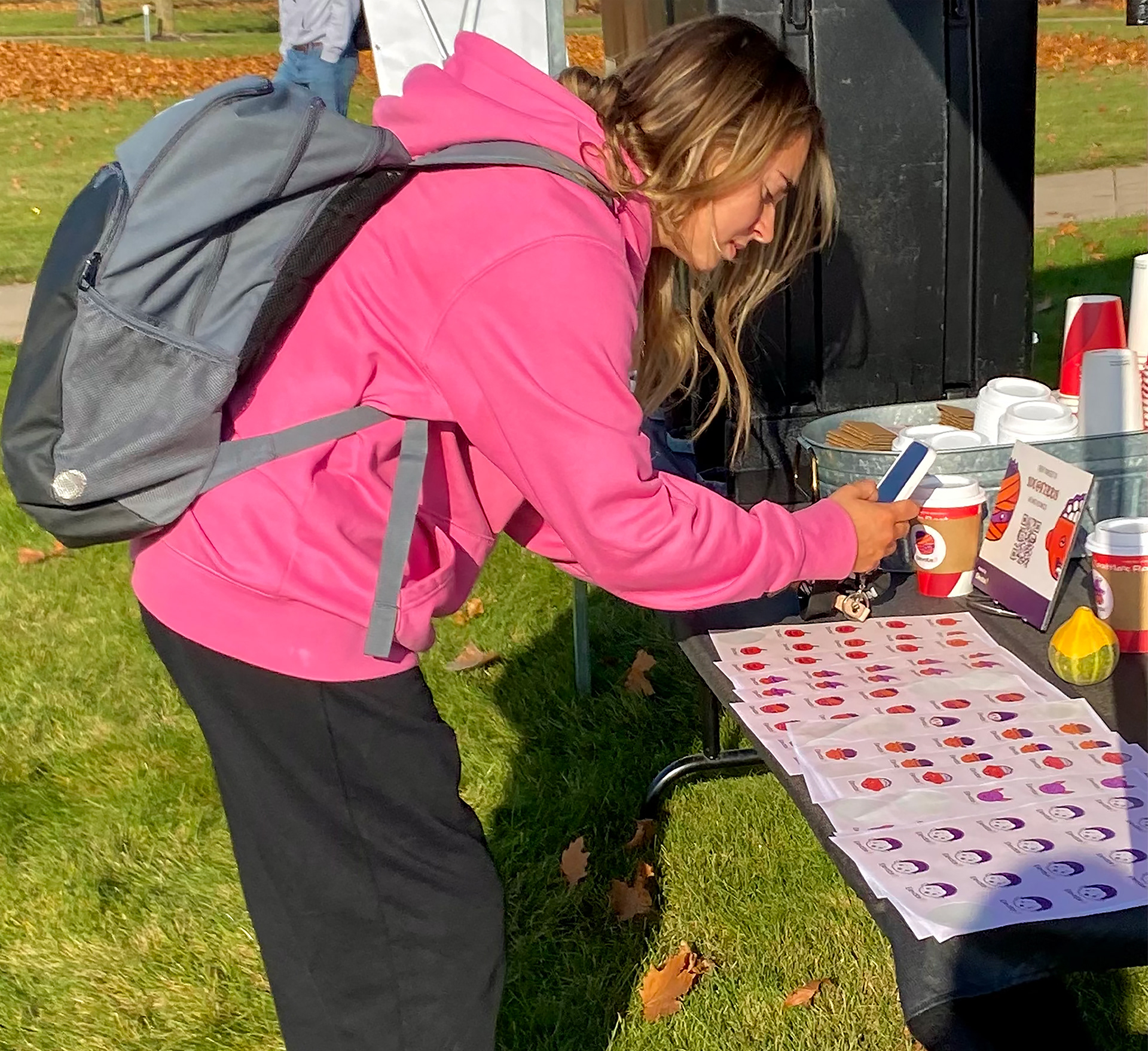 Students scan the QR code sign to receive wellness resources