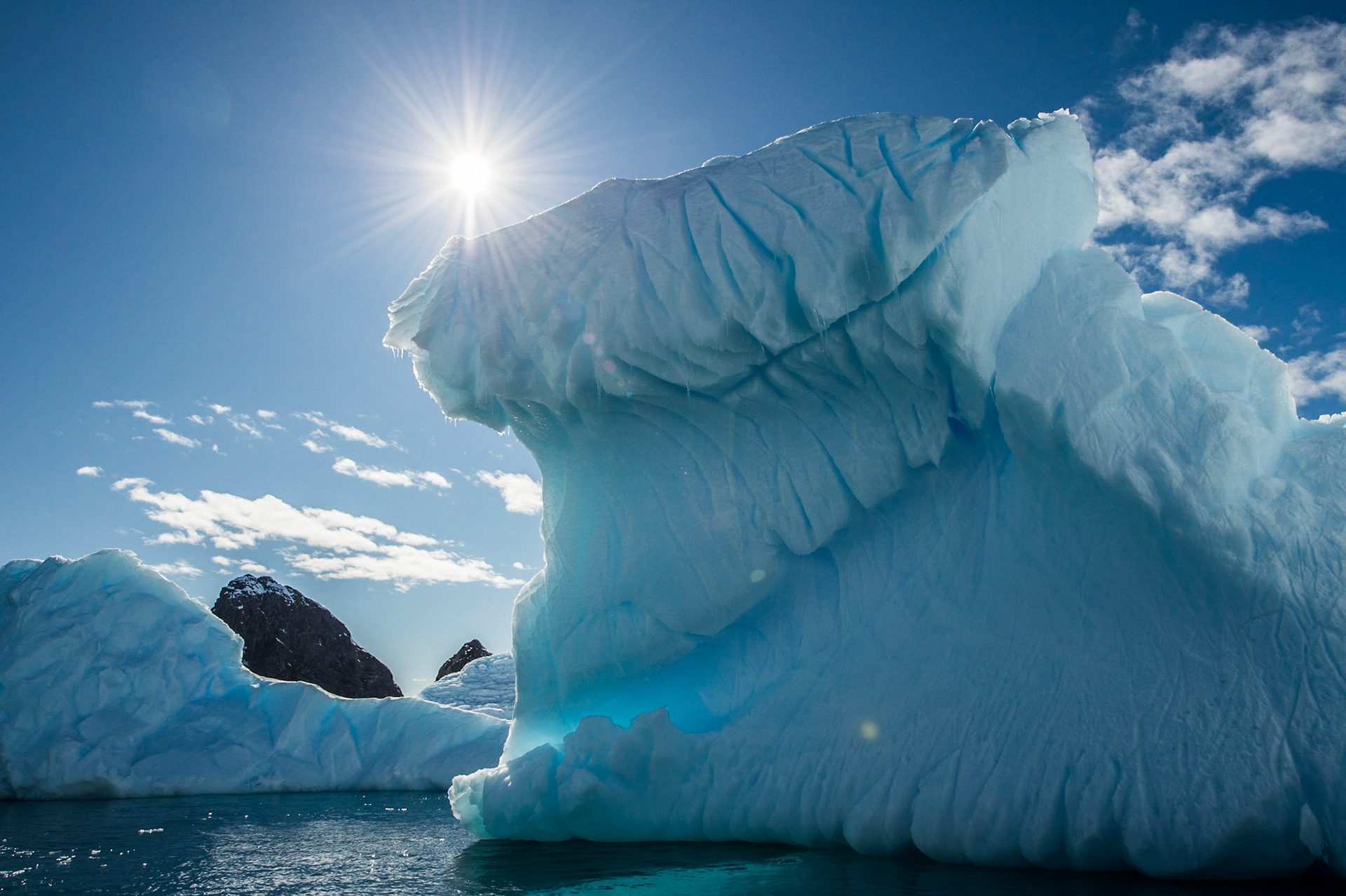 Sun over an iceberg near Astrolabe Island, Antarctica