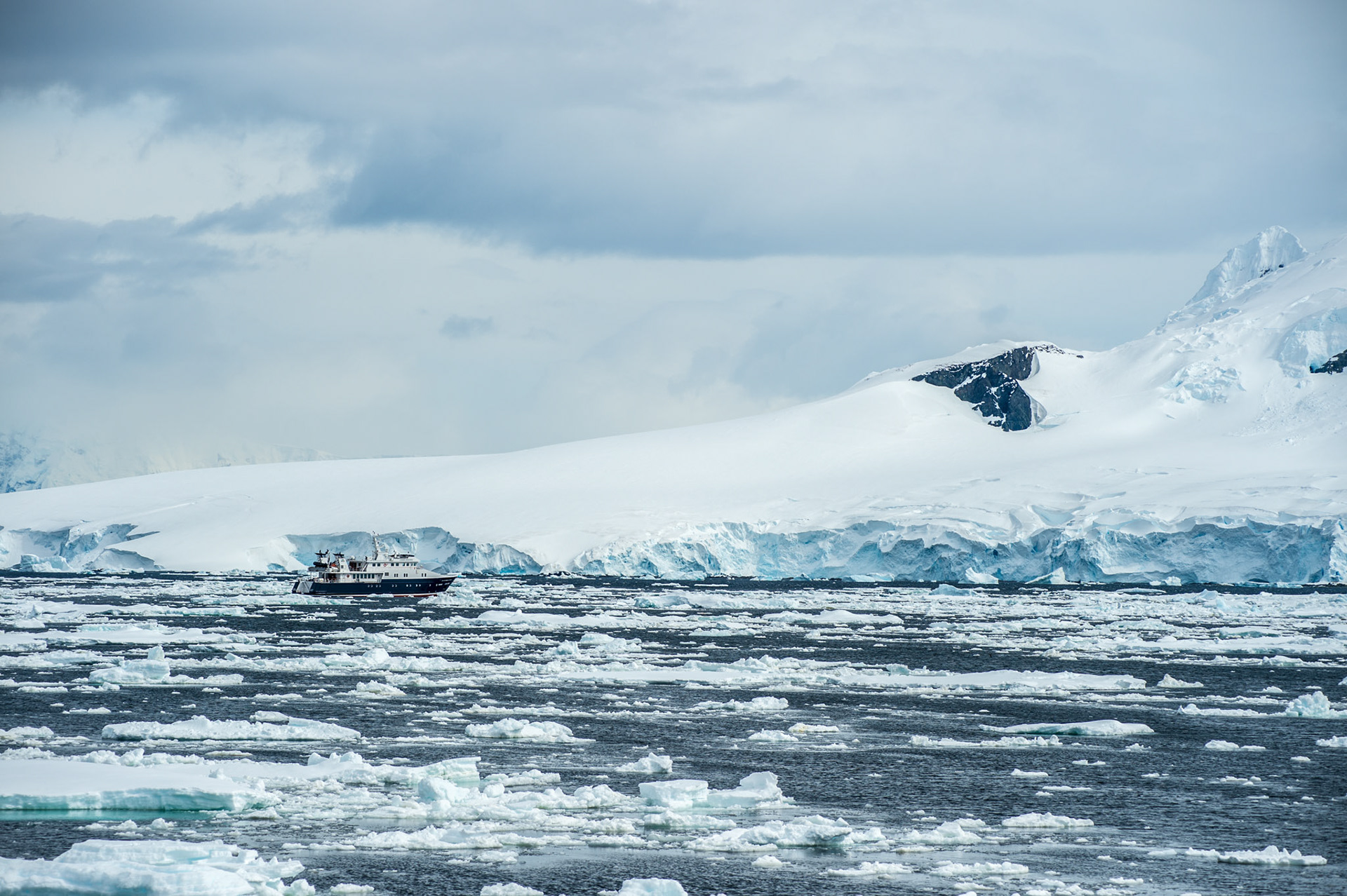 Ship among the pack ice, Neumayer Channel, Antarctica