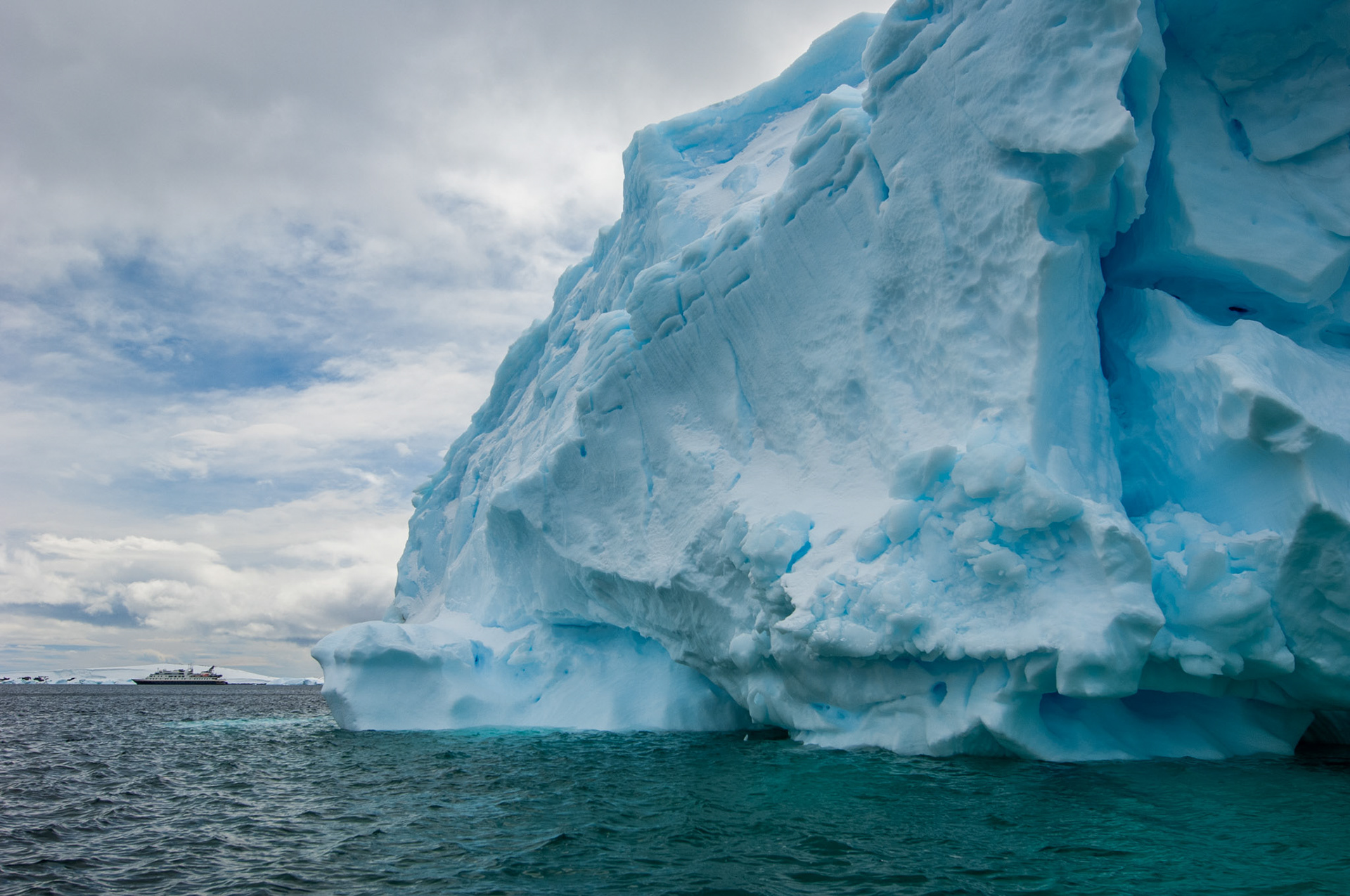 Iceberg with ship in the background, Cuverville Island, Antarctica