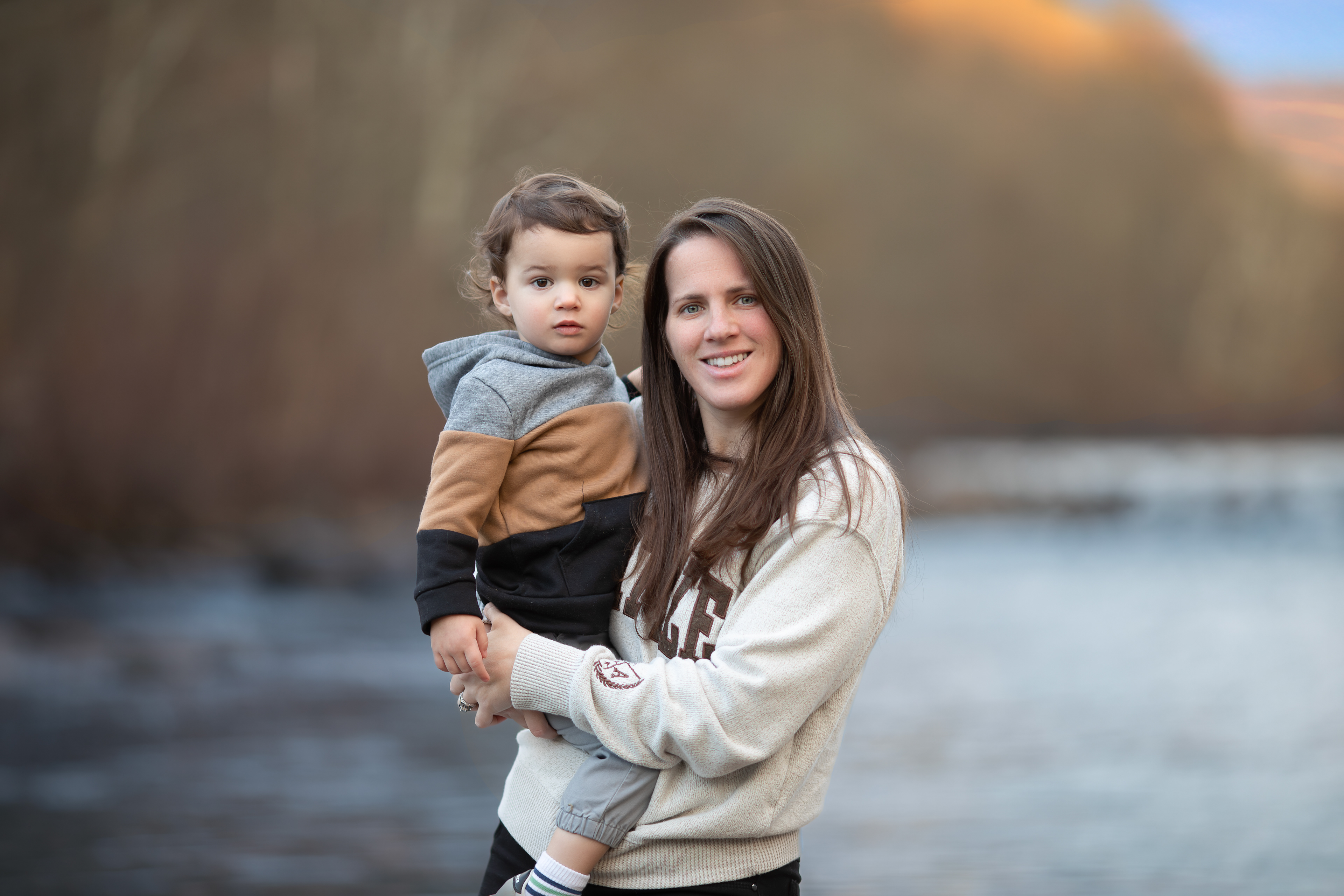 Mom holding toddler at Greenhouse Park during family session by Inclined Shutter