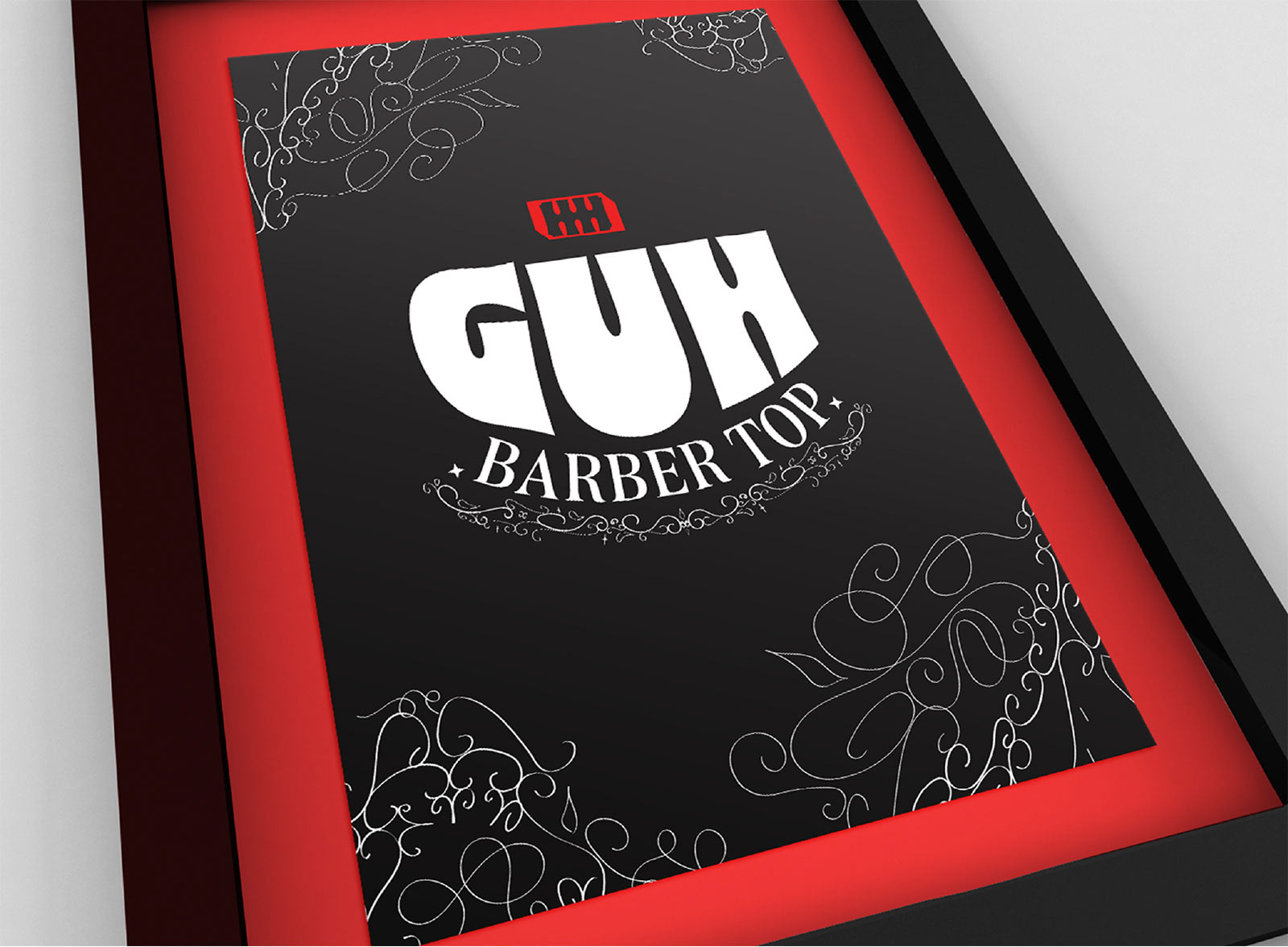 Quadro da barbearia Guh Barbertop com logotipo estampado.
