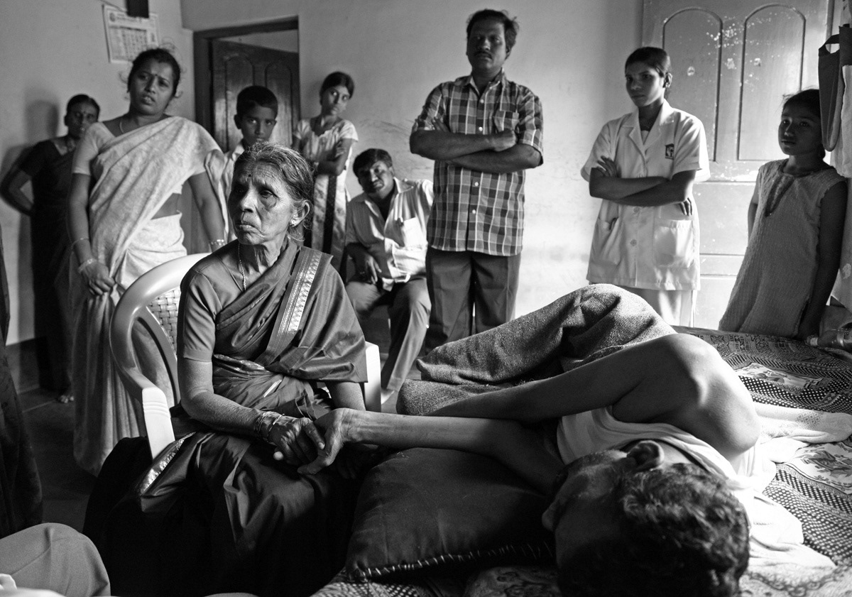 Kumar used to drive tempos and mini-buses in Bangalore. He was 33 in 2012 when he discovered he had lung cancer. Six months later, he was dying. On a December morning, his family was summoned to meet him. They stand by his bed as his favourite aunt clasps his hand tightly.