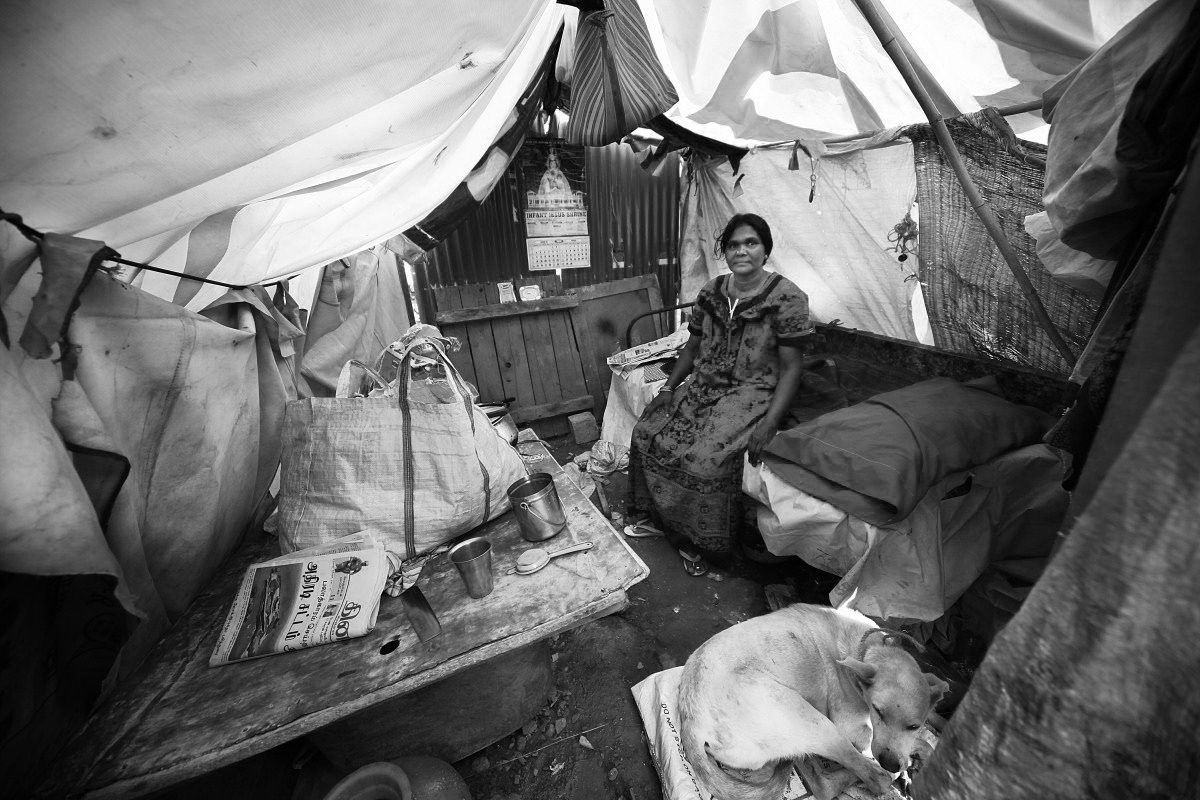 Theresa, 45, used to have a shop in EWS Ejipura and earned Rs 200 per day. She is now unemployed and lives in this roadside tent over a drain.