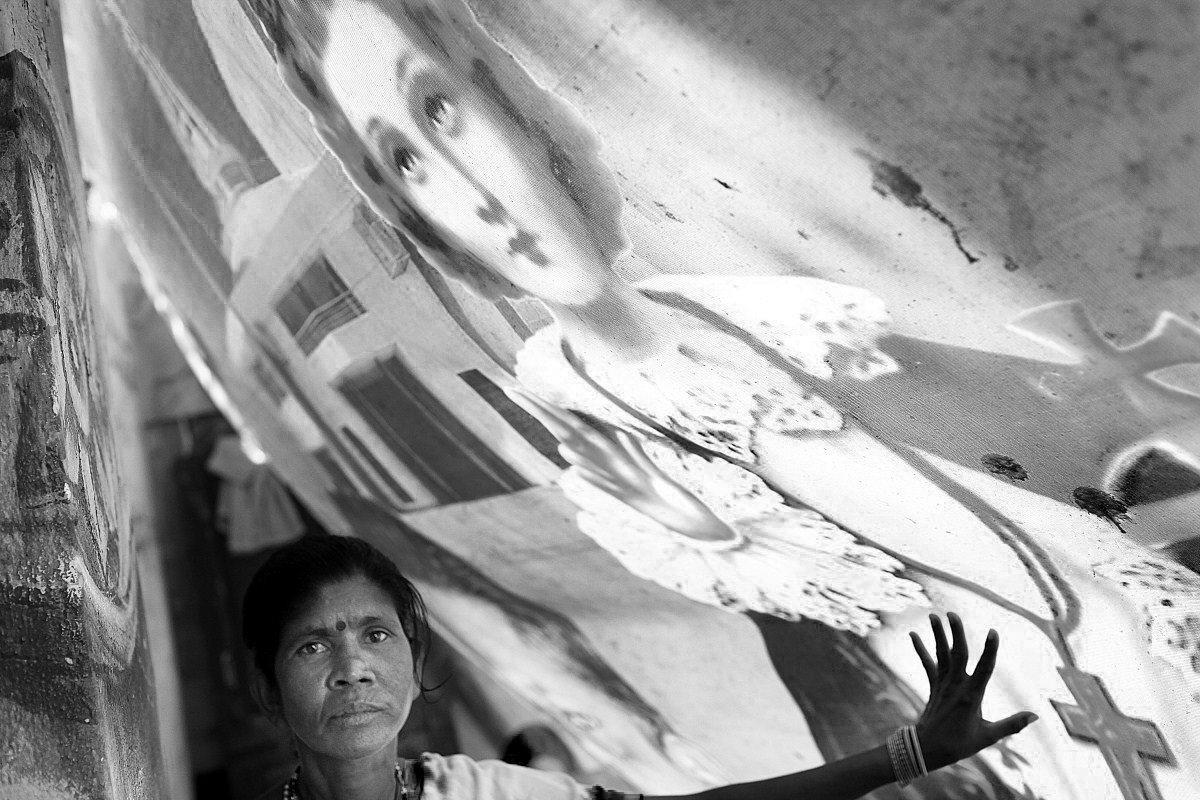 Anthonyamma, 56, works as a canteen cleaner from 6 AM to midnight. She has lived in Ejipura, Bangalore, for 20 years, but now uses a banner from a local church as a roof and wall