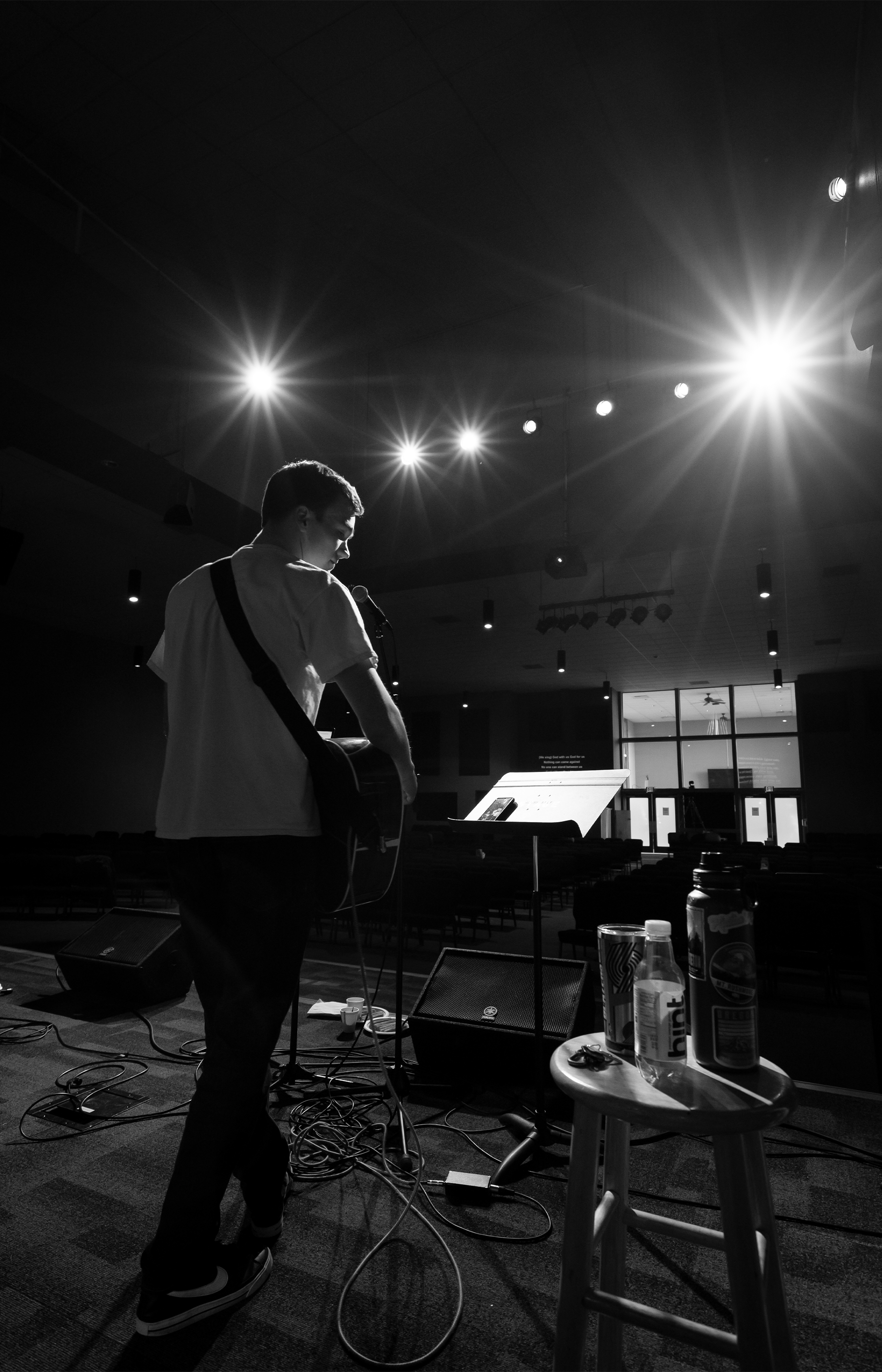 High schooler Cole Christensen leads the worship team through rehearsal on a Friday evening after school.