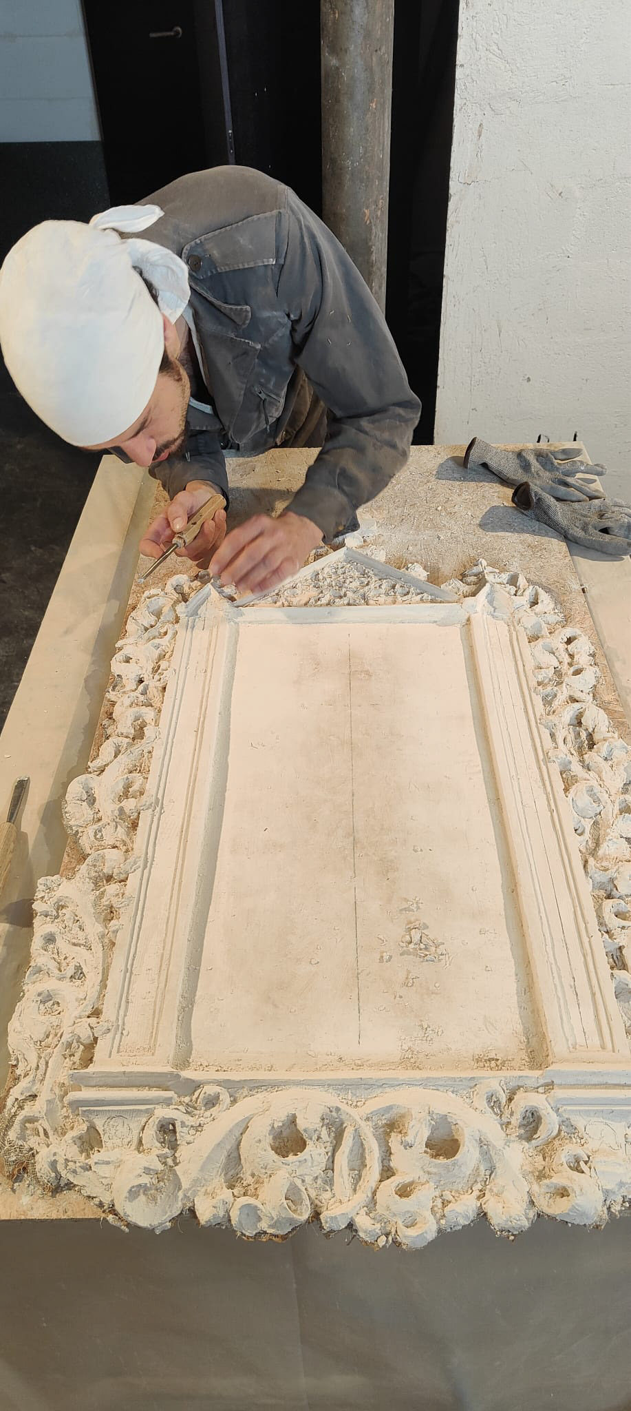 Axel Bertone carving Agnus Dei from a plaster block