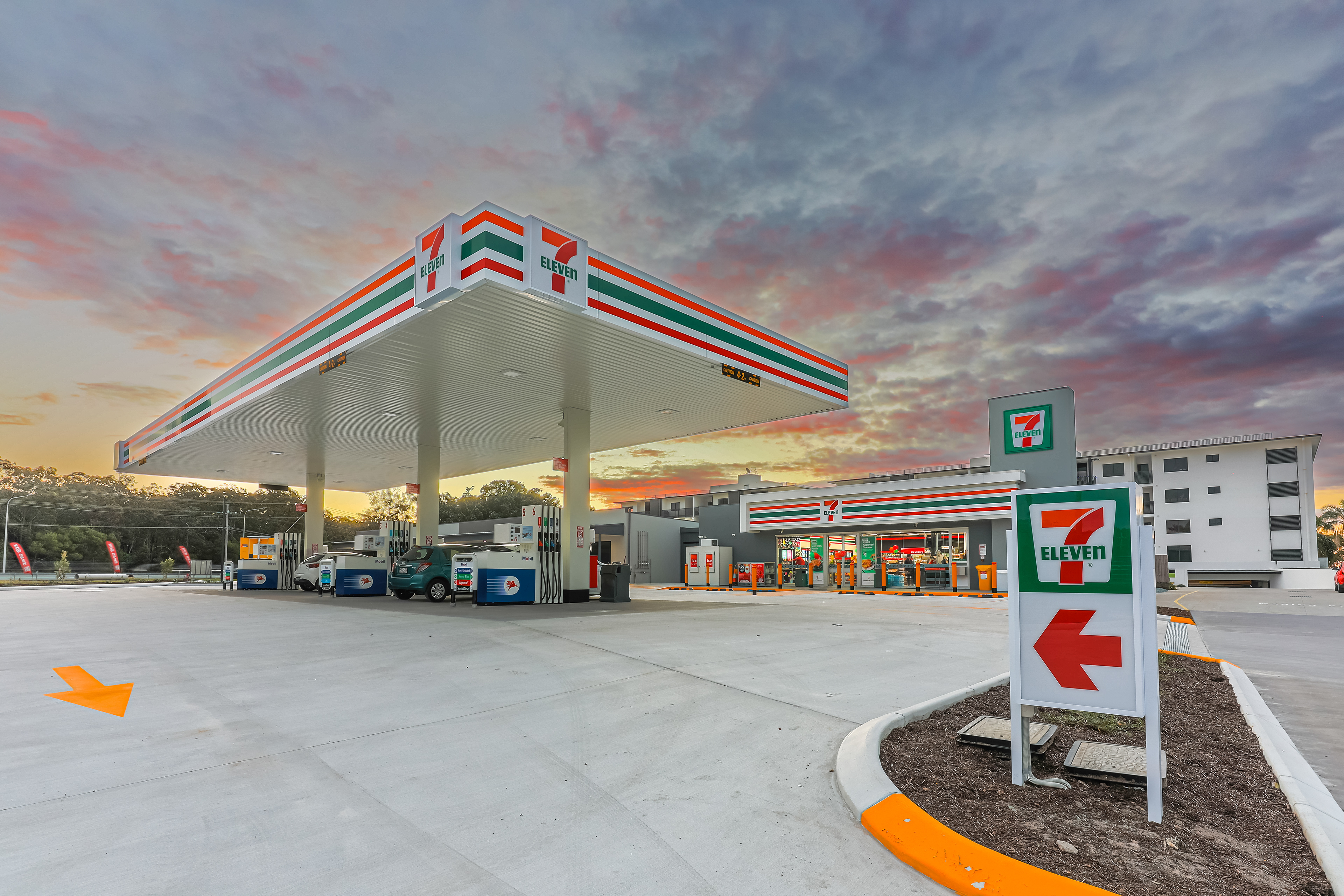 7-Eleven gas station and convenience store with modern amenities and bright signage, photographed at sunset for a dynamic visual appeal, located in Ipswich, QLD. Professional commercial photography by Jeremy Murphy.