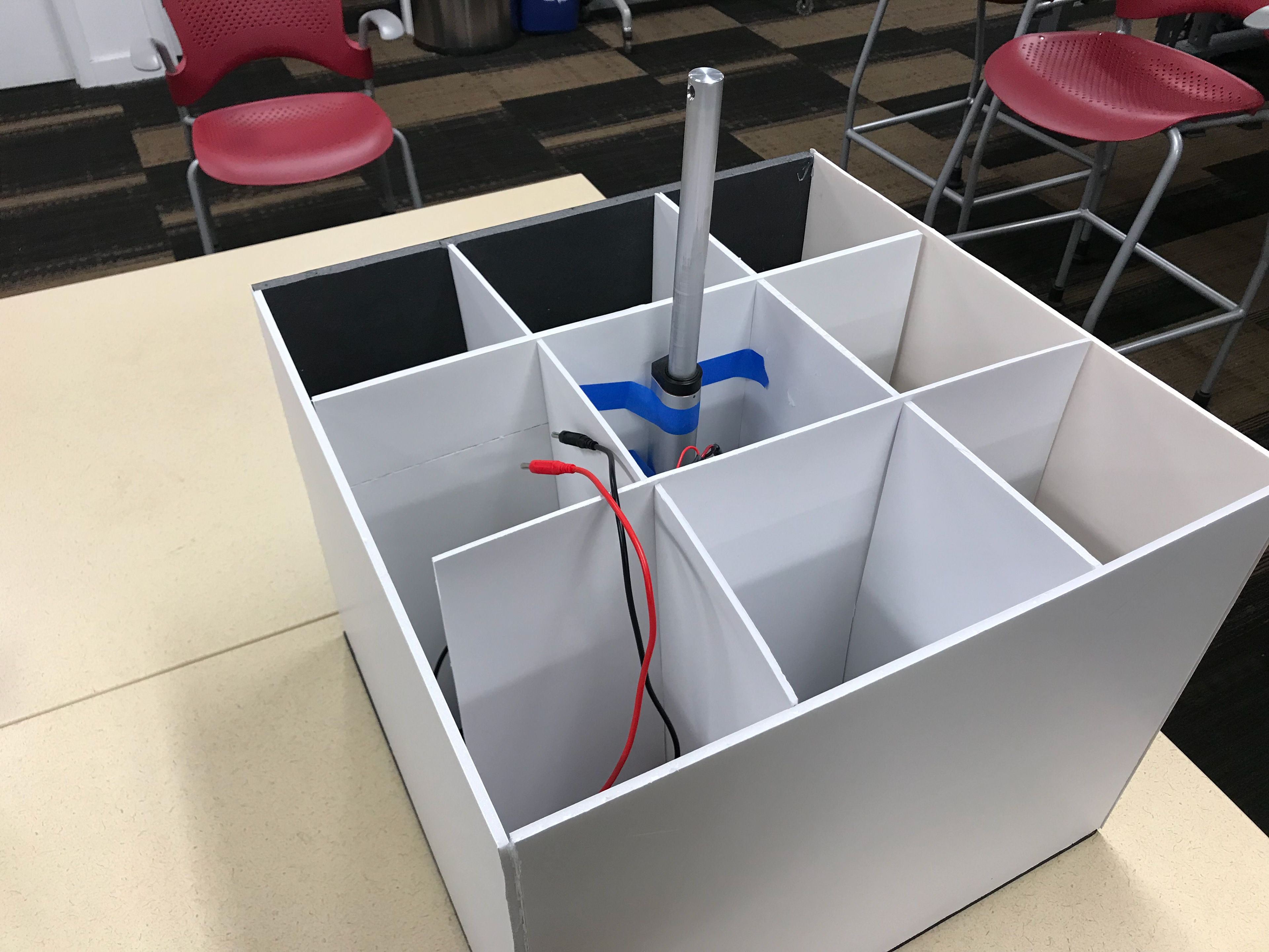 One of the early prototypes, testing the use of a linear actuator to tip the trashcan over.