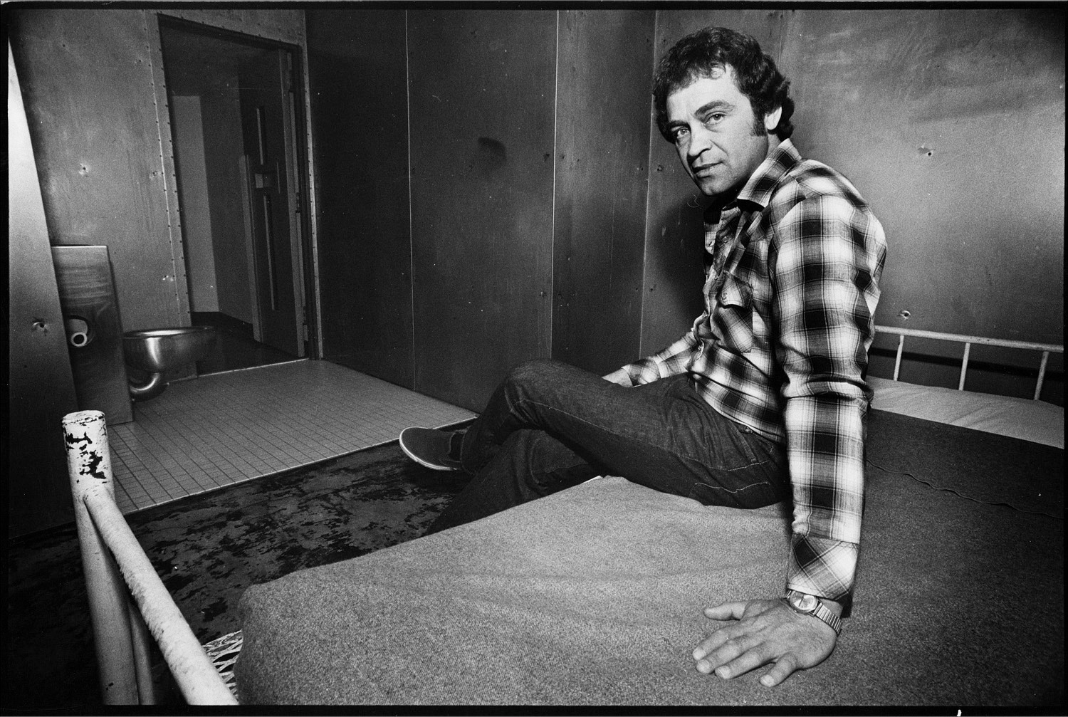 Writer and Convict Ed “Hacksaw” Jones in his cell with metal walls. He escaped from custody many times over the years.