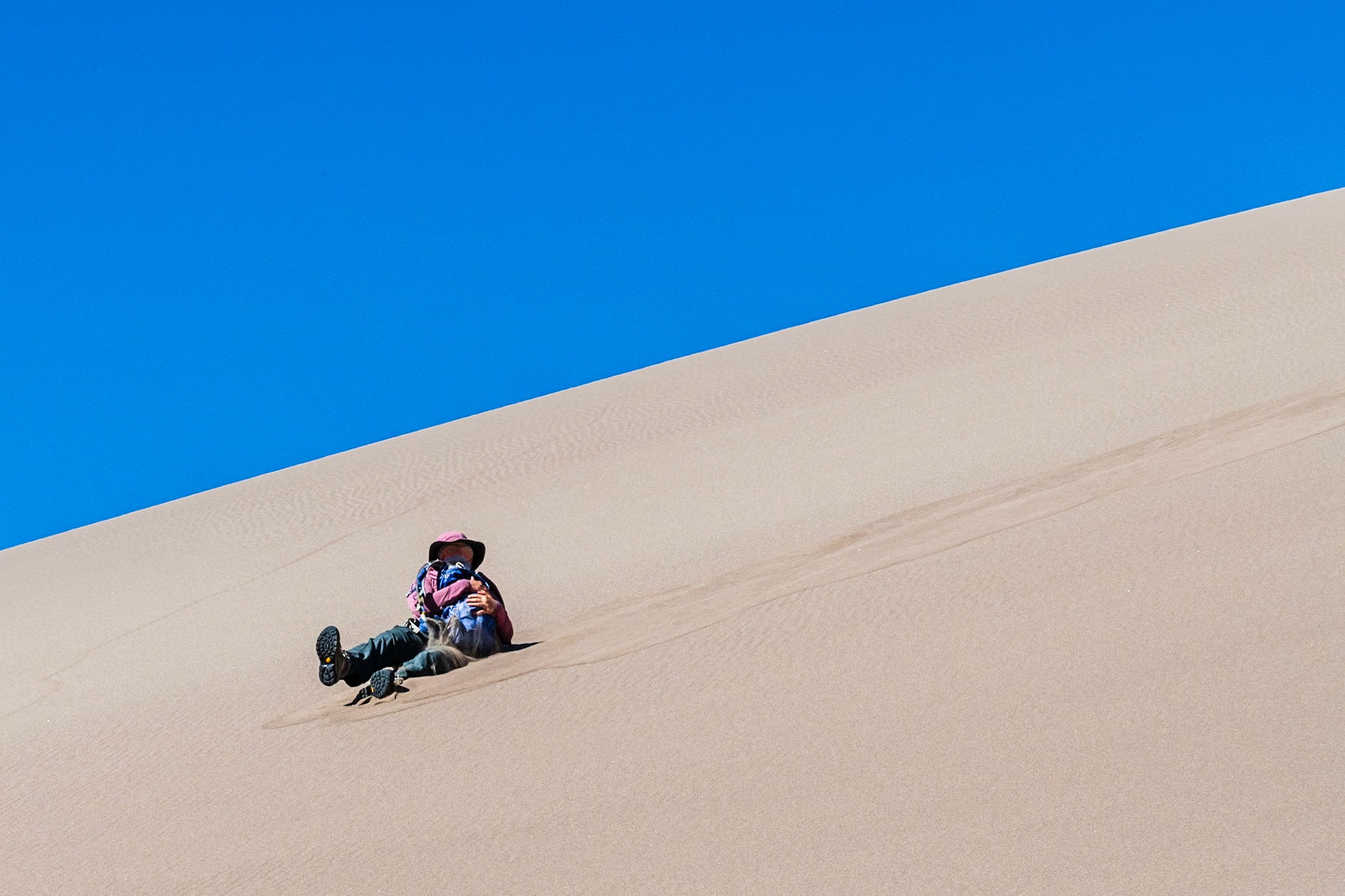 Sliding down the sand dunes.