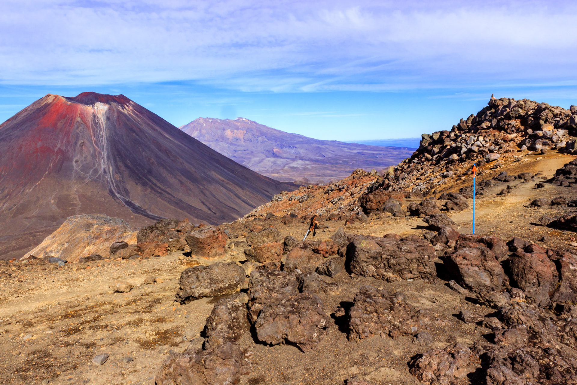 View of all three active volcanoes. Ngauruhoe on the left, Ruapehu in the center, and Tongariro in the foreground on the right.
