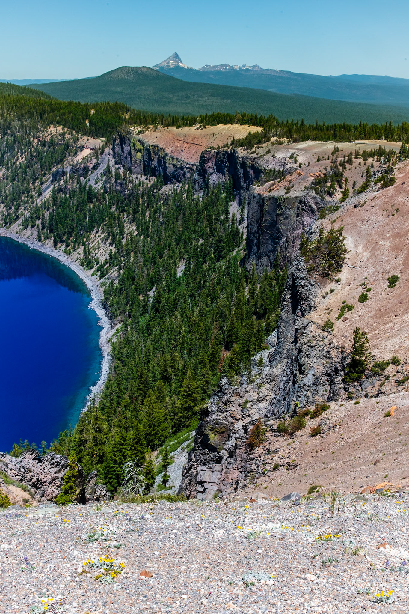 View of Grotto Cove on Crater Lake with Mount Thielsen