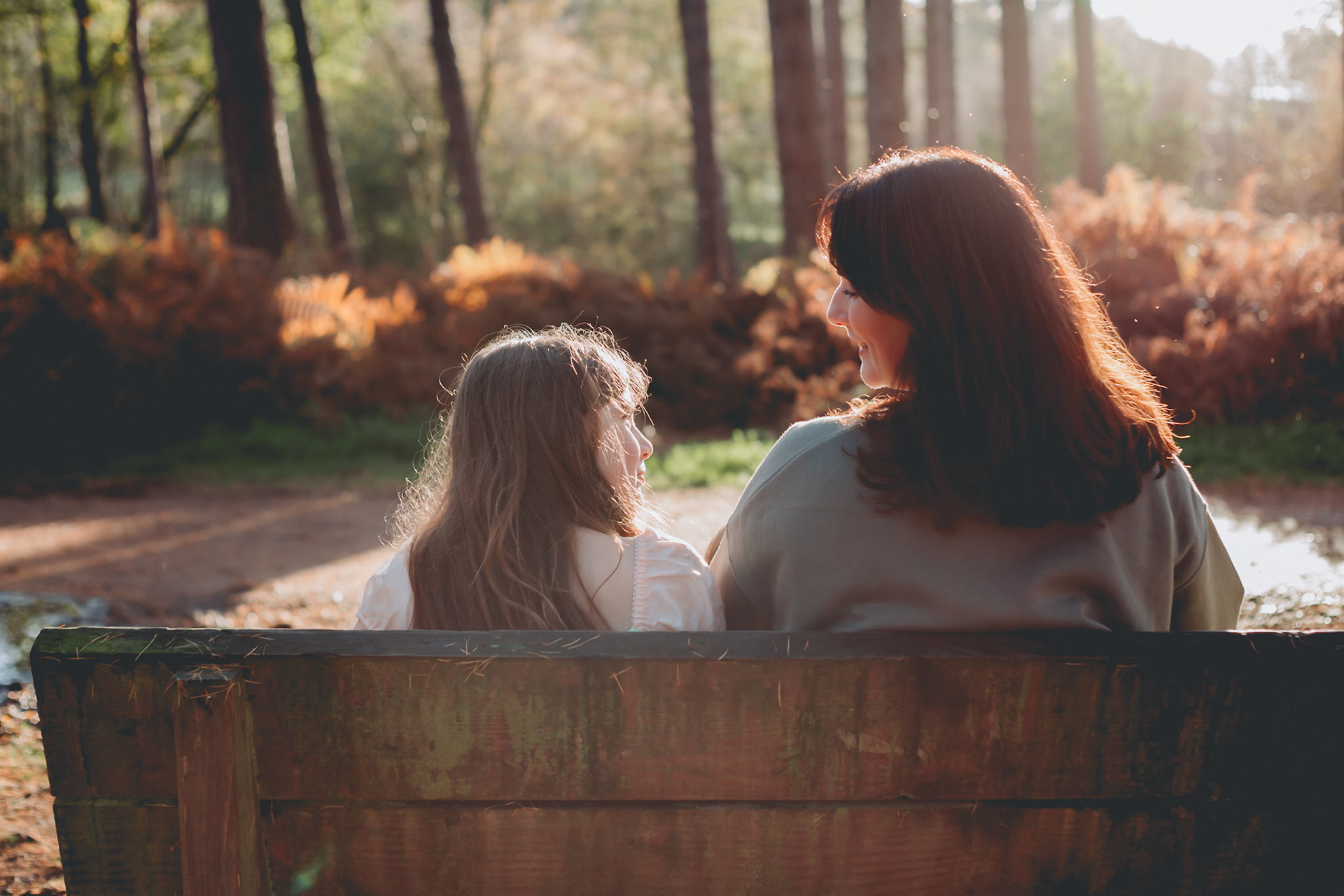 mum and daughter sitting on a bench