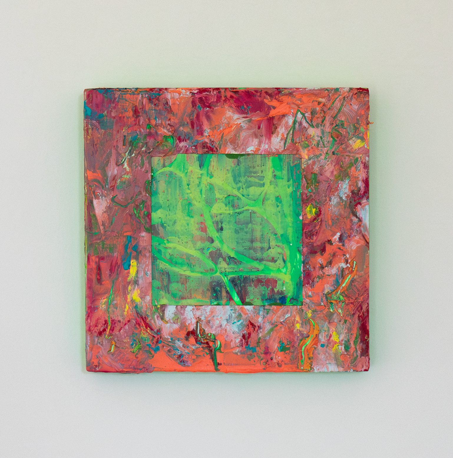 Untitled 'a season'. Oil on board, 15x15cm. Front view of textural abstract painting with thick impasto surface with colours of peach, orange, red and yellow. In the centre there is a cut away square exposing a green and yellow textural underpainting. The edges of the painting are neon green which is reflecting on the white wall to make a green glow.