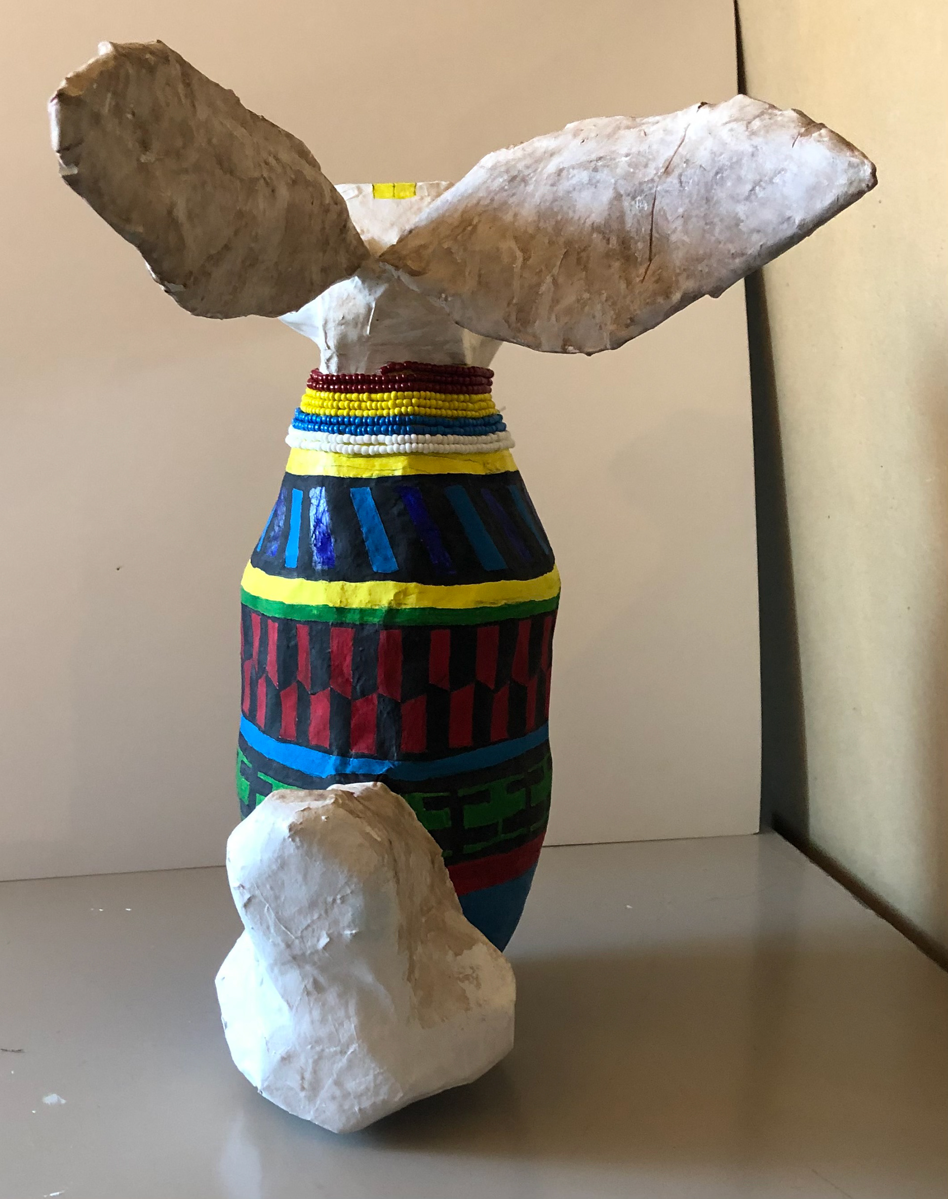 With his two fiery twigs, he grabs fire back to the Seminole tribe. Created with paper-mache and painted with gouache. 20'X18'
