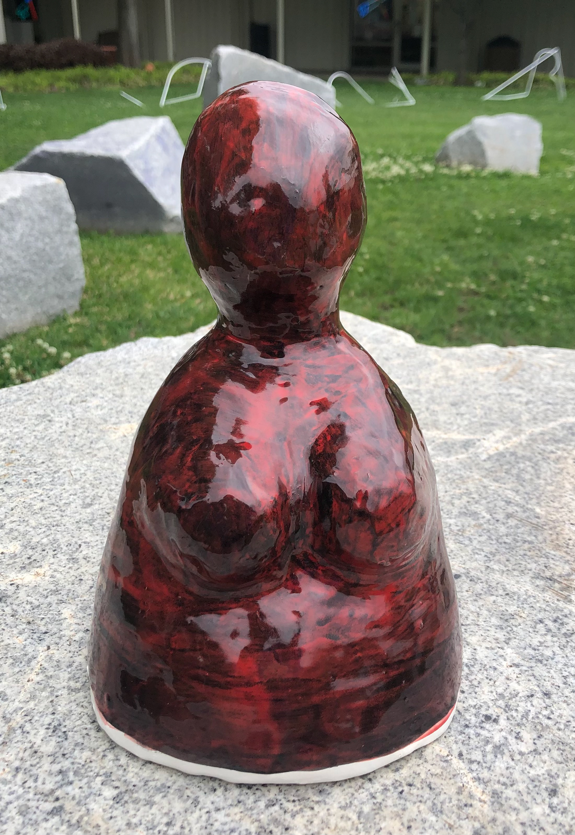 Low fire clay, bright red over black glaze.