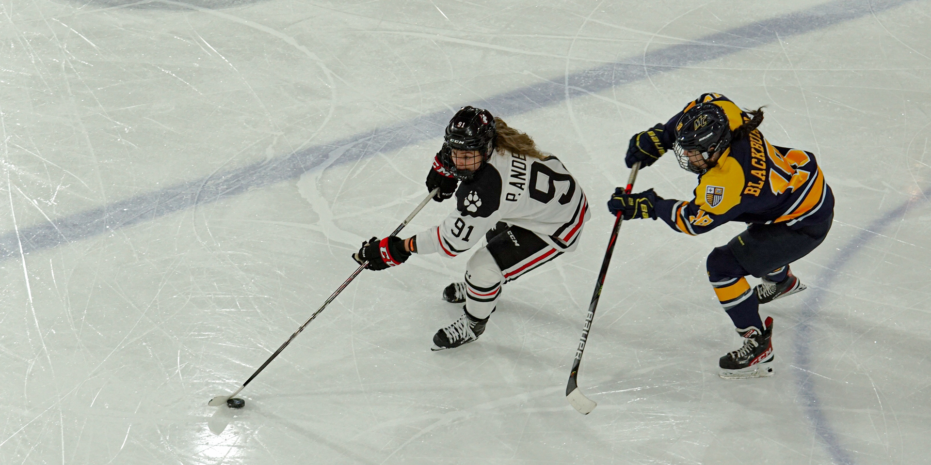 #91 Peyton Anderson keeps control of the puck from Merrimack.