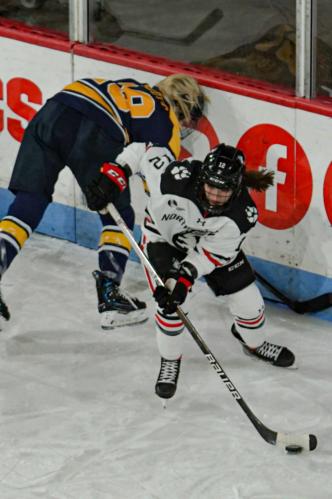 #12 Chloé Aurard steals the puck from Merrimack