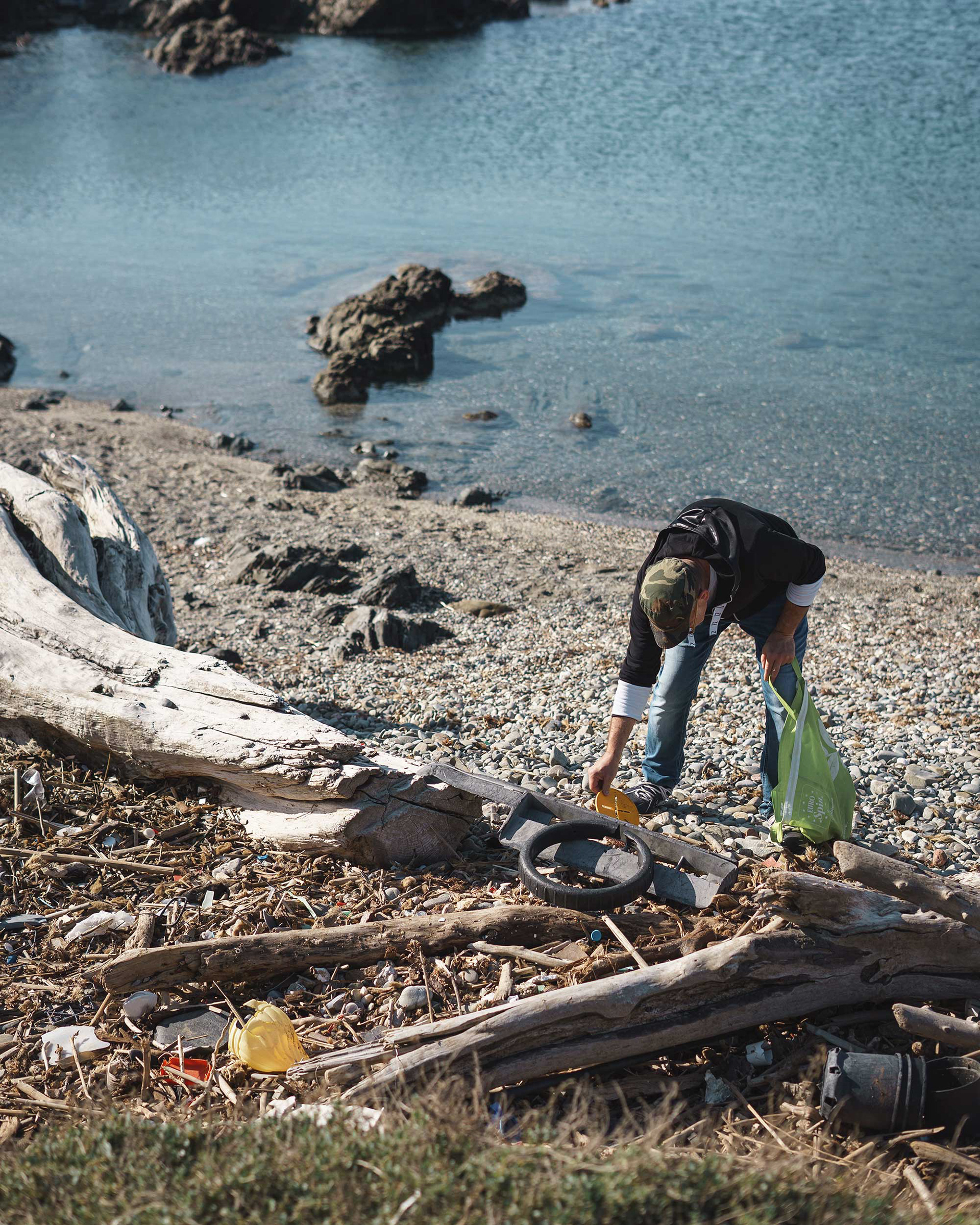 Artist Maurizio Sergiusti collecting plastic waste from Sardinian beach for environmental art project Plastic from the Abyss