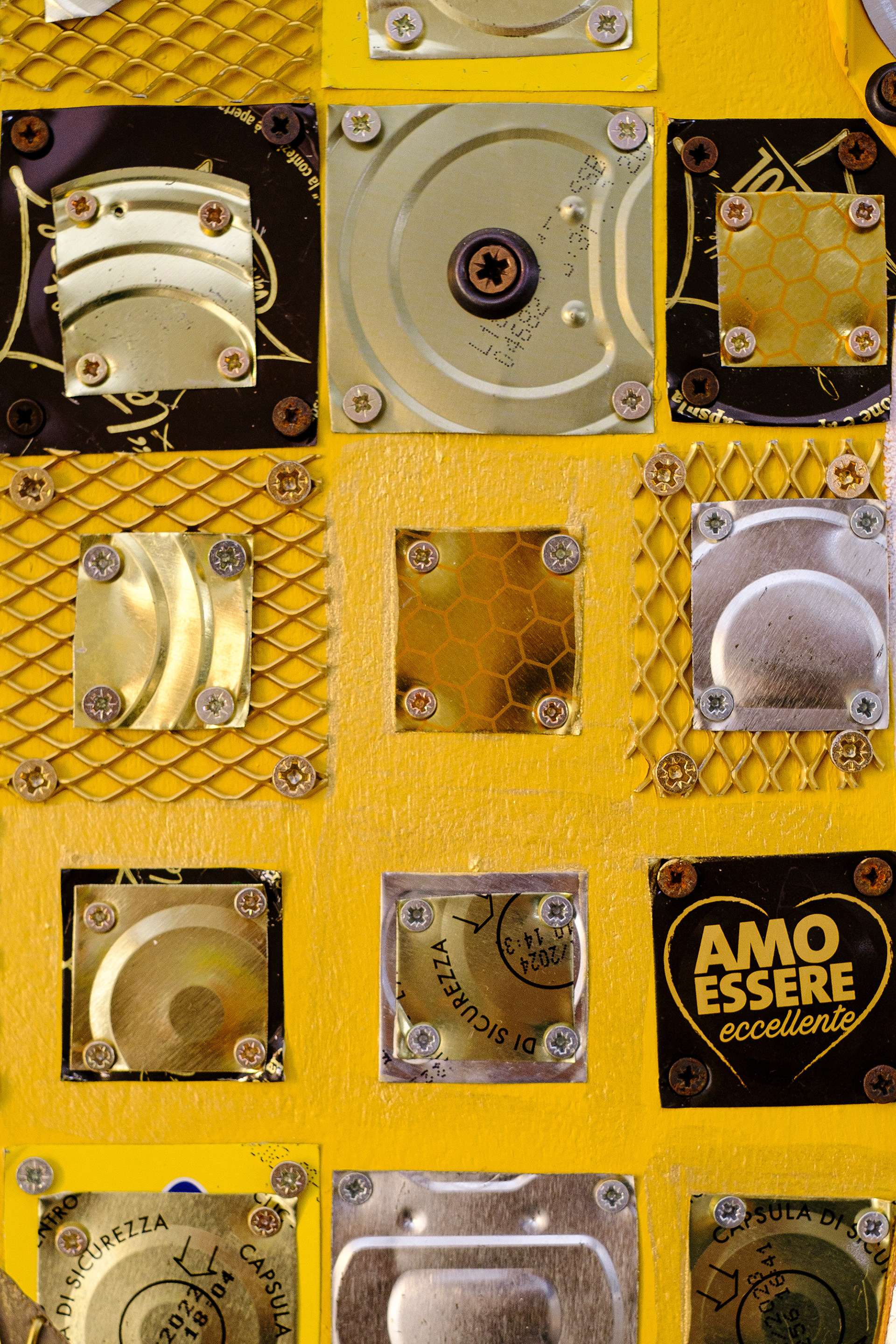 Grid pattern assemblage with electronic waste and CD components