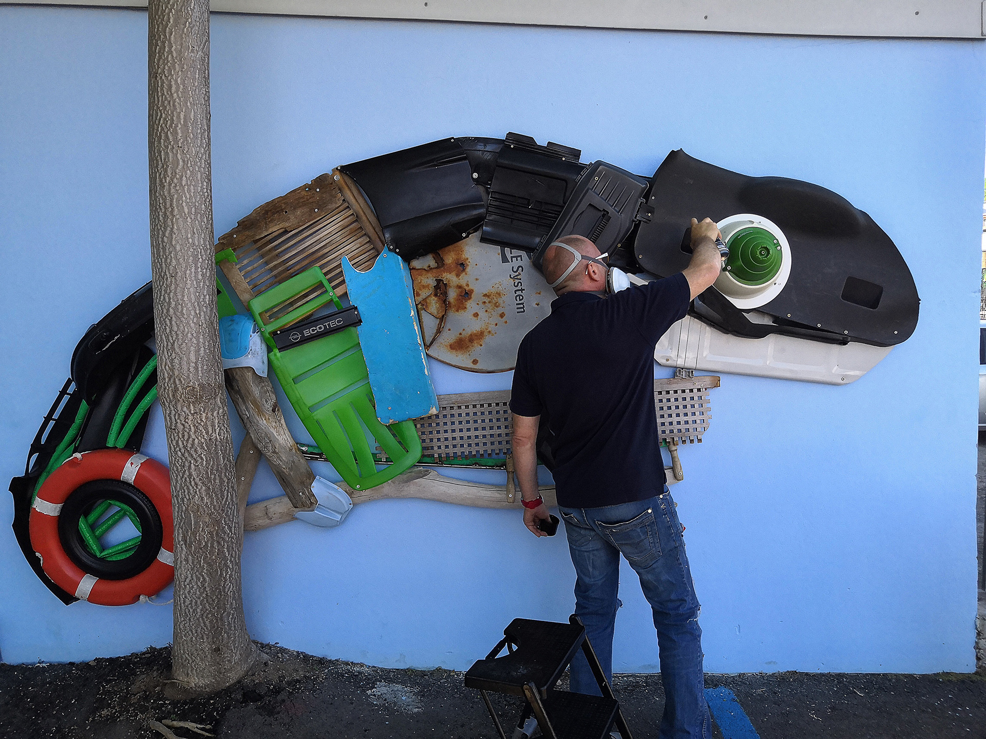 Scoobafish mounting reclaimed plastic components during the construction of Giant Chameleon.