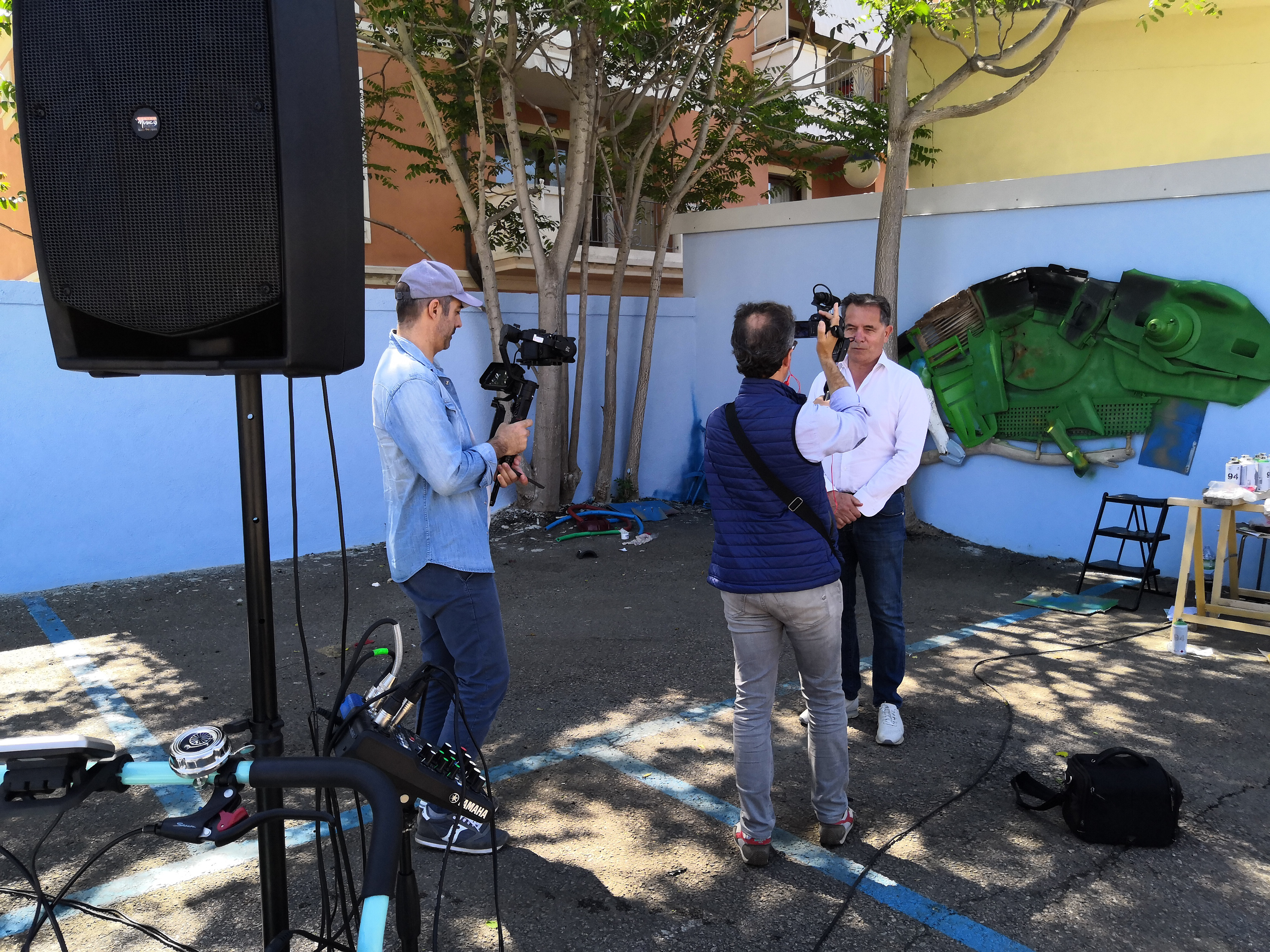 Olbia mayor Settimo Nizzi being interviewed with Giant Chameleon under construction in the background.