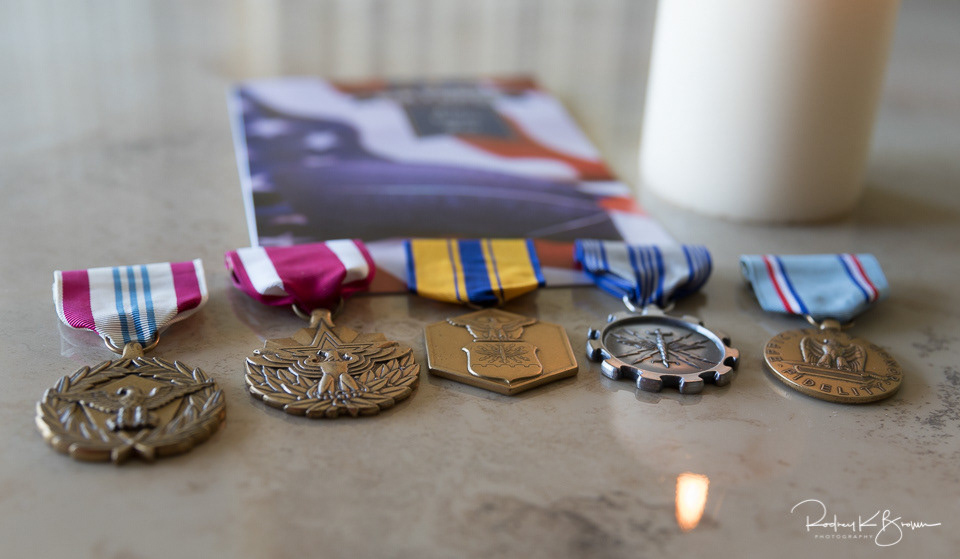 Military medals on display with Veterans Day card