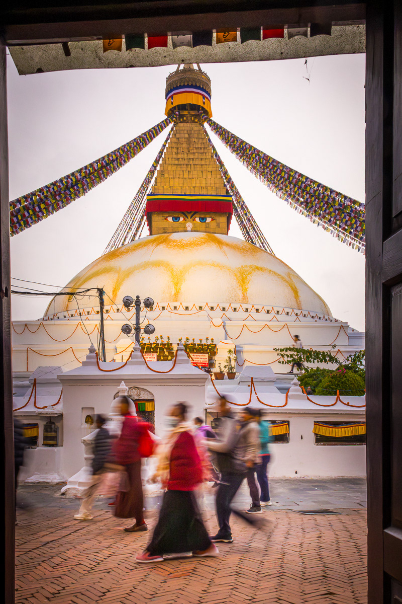 Tibetan Buddhists, monks and pilgrims make ritual circuits of Boudha Stupa in Kathmandu at dawn