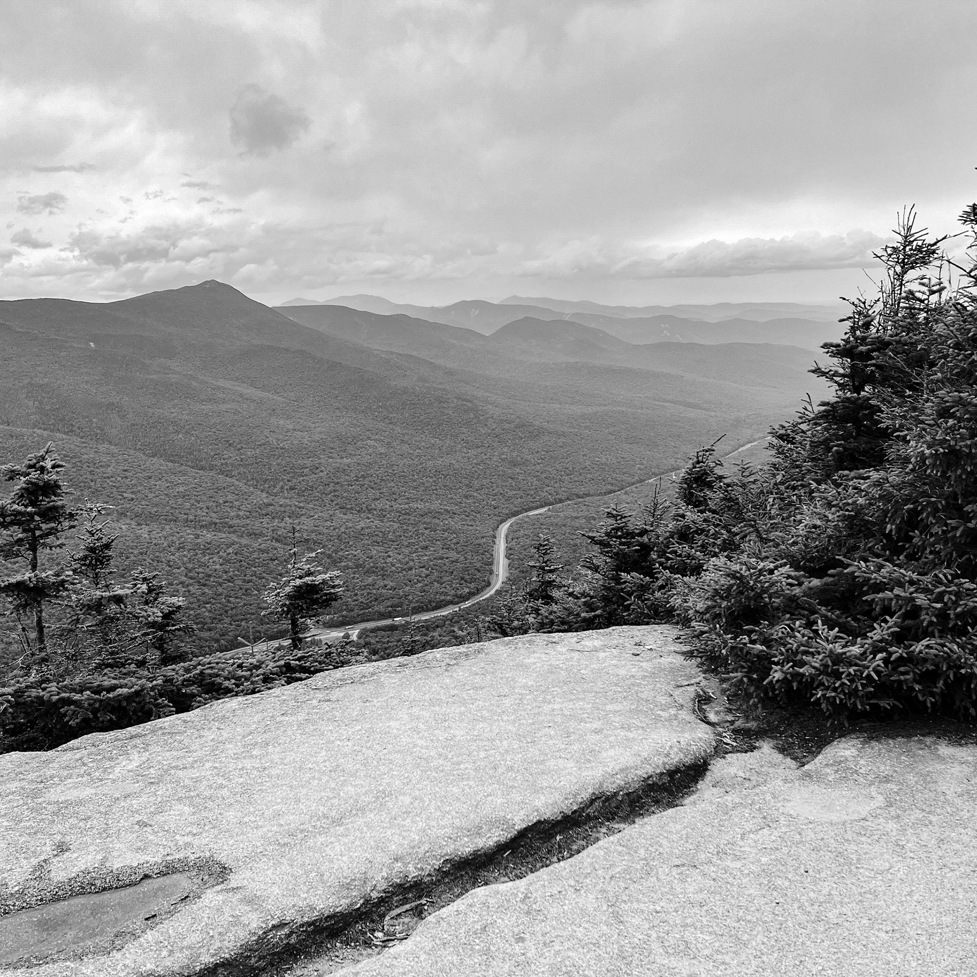Franconia Notch from the Rim Ridge Trail. In the Notch is I-93, but it is unchanged from Federal Route 3. Supposedly this is one of only two places in the US where an interstate highway stops looking like an interstate and instead effectively becomes the old two-lane Federal road.