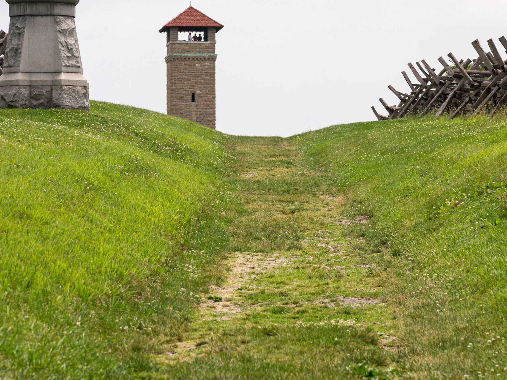 The Sunken Road. Sunken below the surrounding fields, for whatever reason, this lane provided a natural snipers pit that Confederate troops made use of. Thousands of Union soldiers came from the north, and as they crested the field immediately north of the lane, they were mowed down. At length the Union gained the lane, and the soldiers who had been firing from the lane were bayoneted to death. The observation tower sits at the end of the lane.