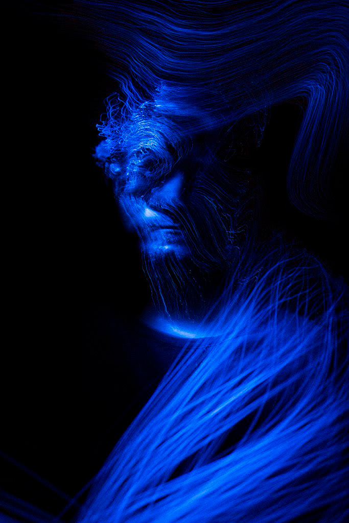A long exposure self portrait photograph showing blue fibres