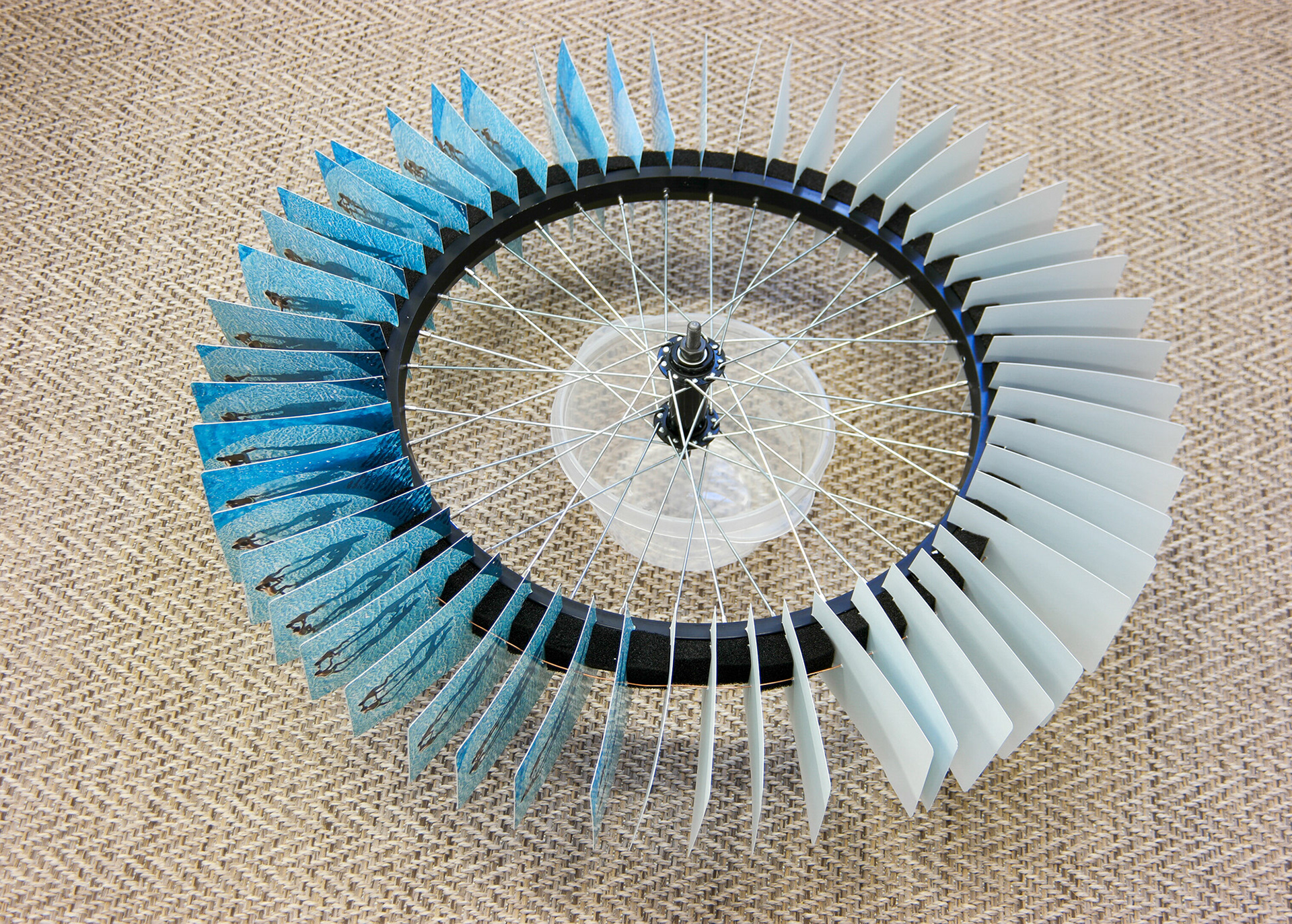 Wheel with 54 photographs mounted top its circumference.