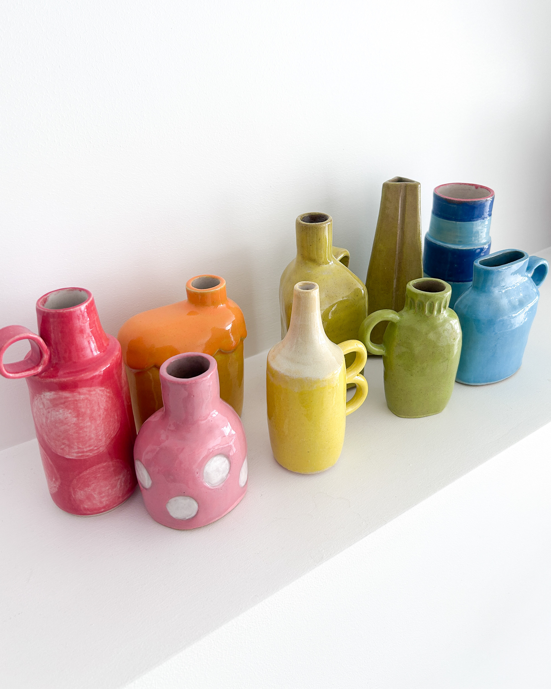 Collection of unique bud vases in all colours of the rainbow in glazed ceramic