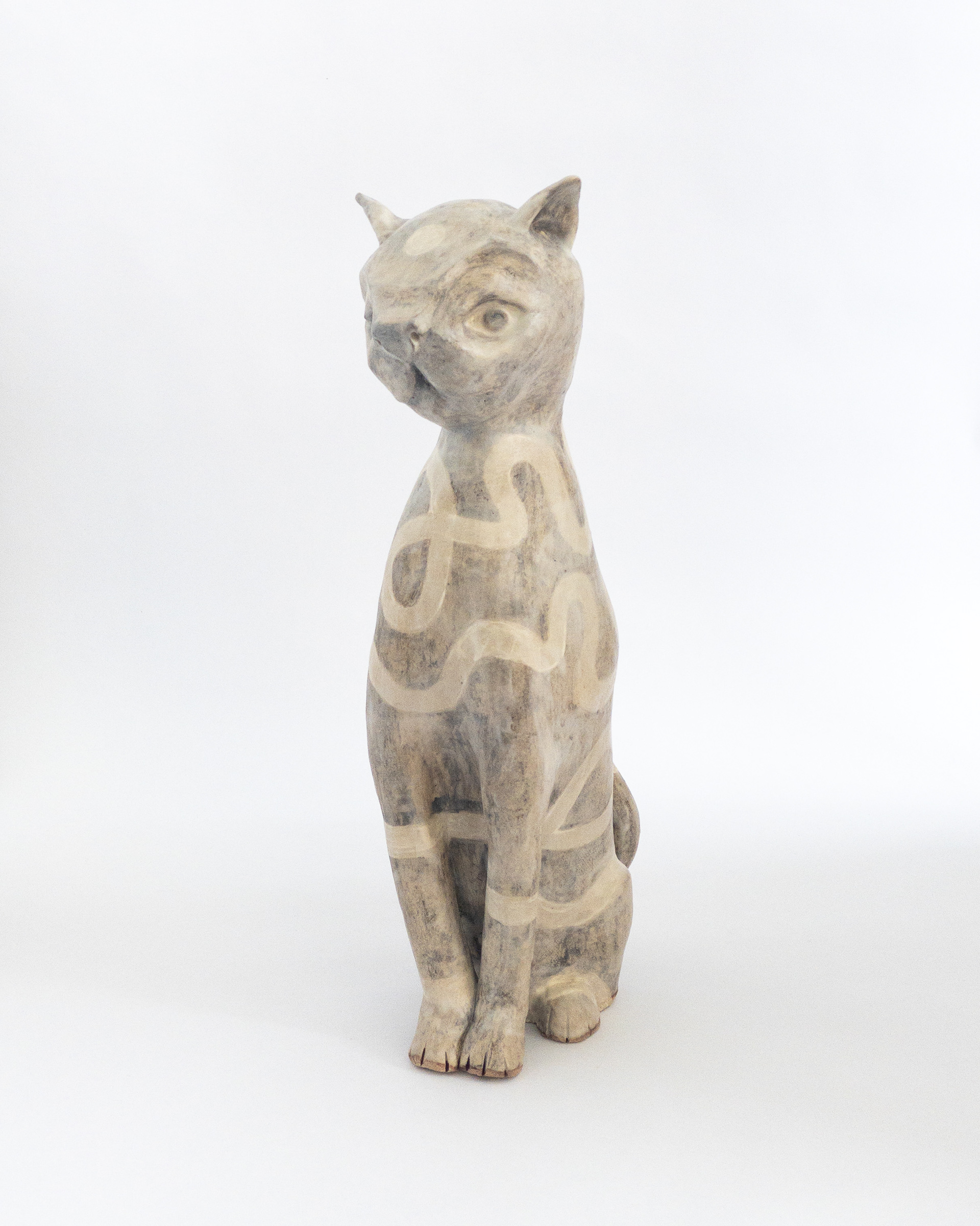 Cat sculpture with wiggly surface decoration in glazed ceramic