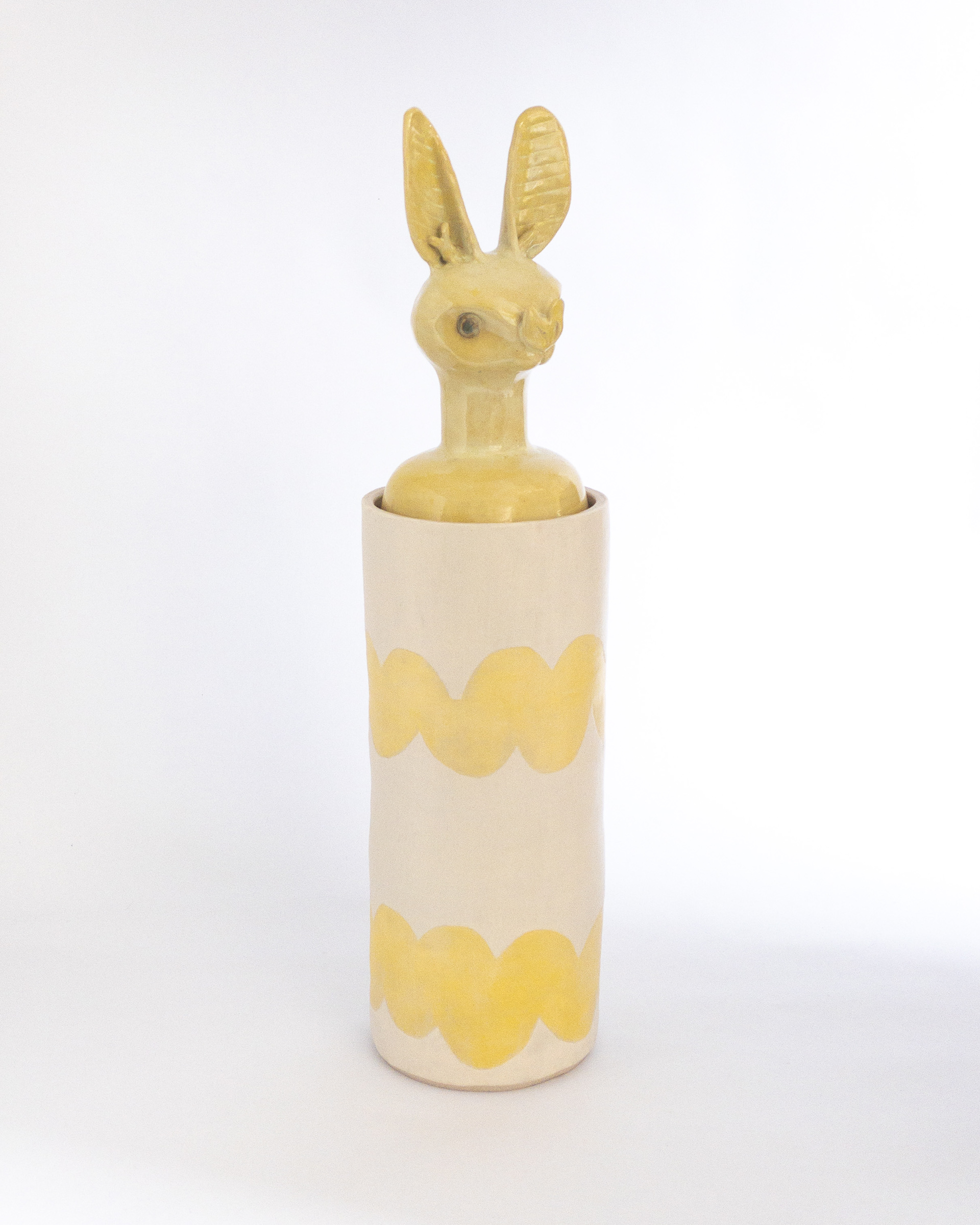 Yellow jar with bat head for lid in glazed ceramic