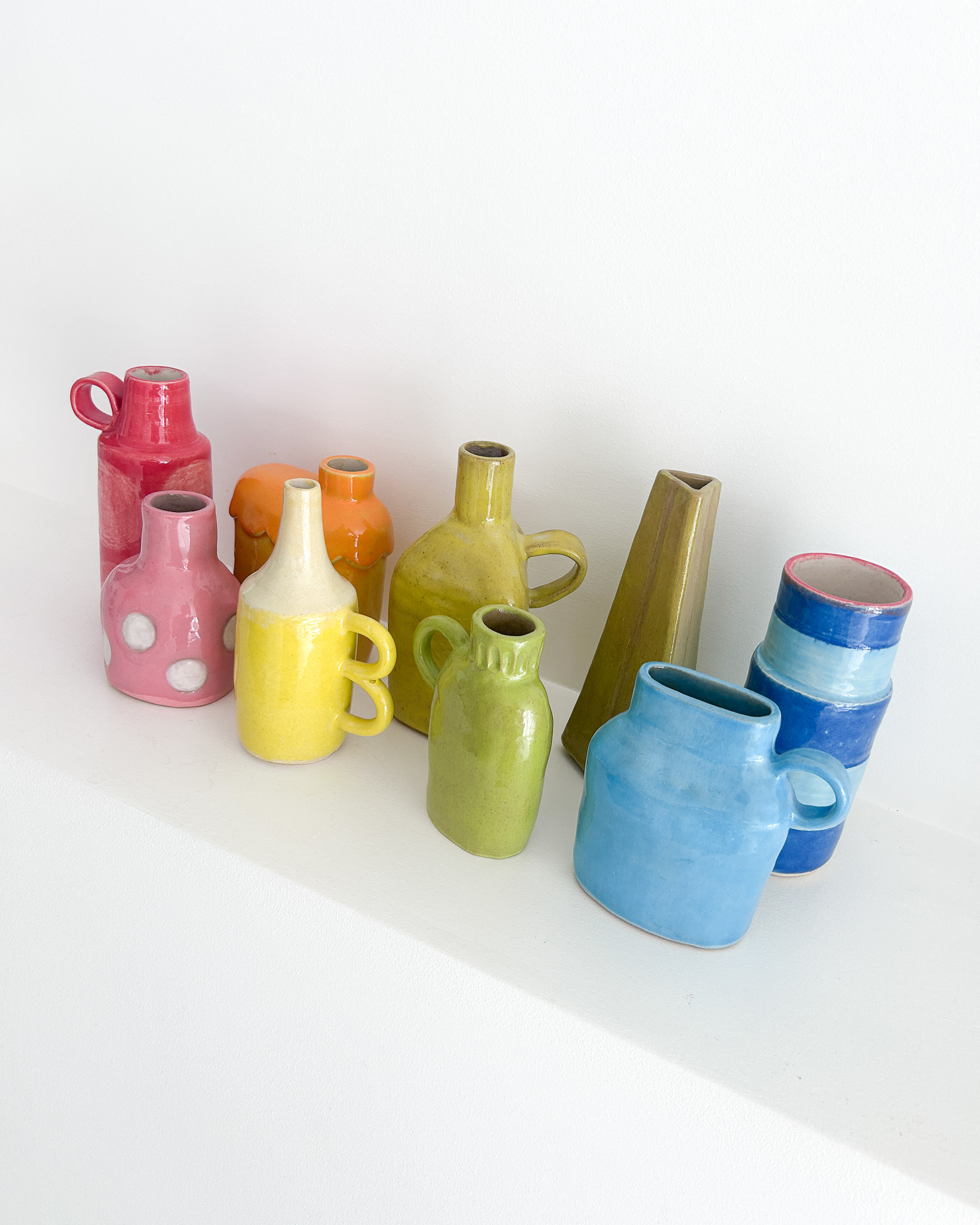 Collection of unique bud vases in all colours of the rainbow in glazed ceramic