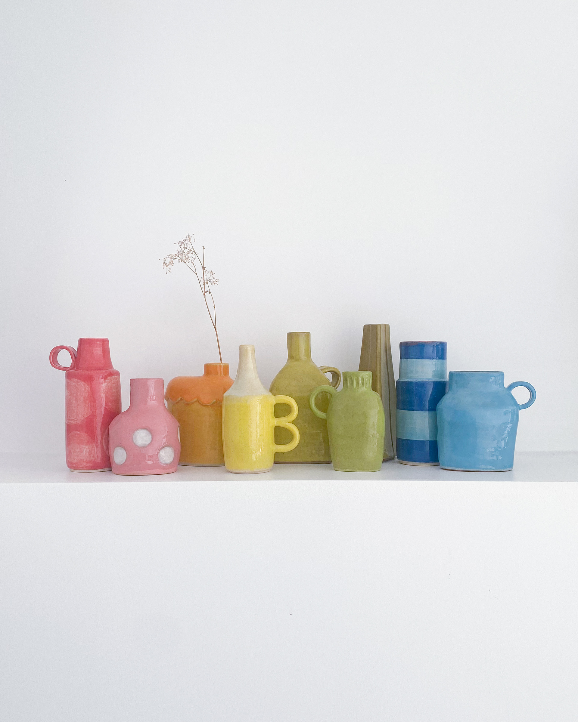 Collection of unique bud vases in all colours of the rainbow in glazed ceramic