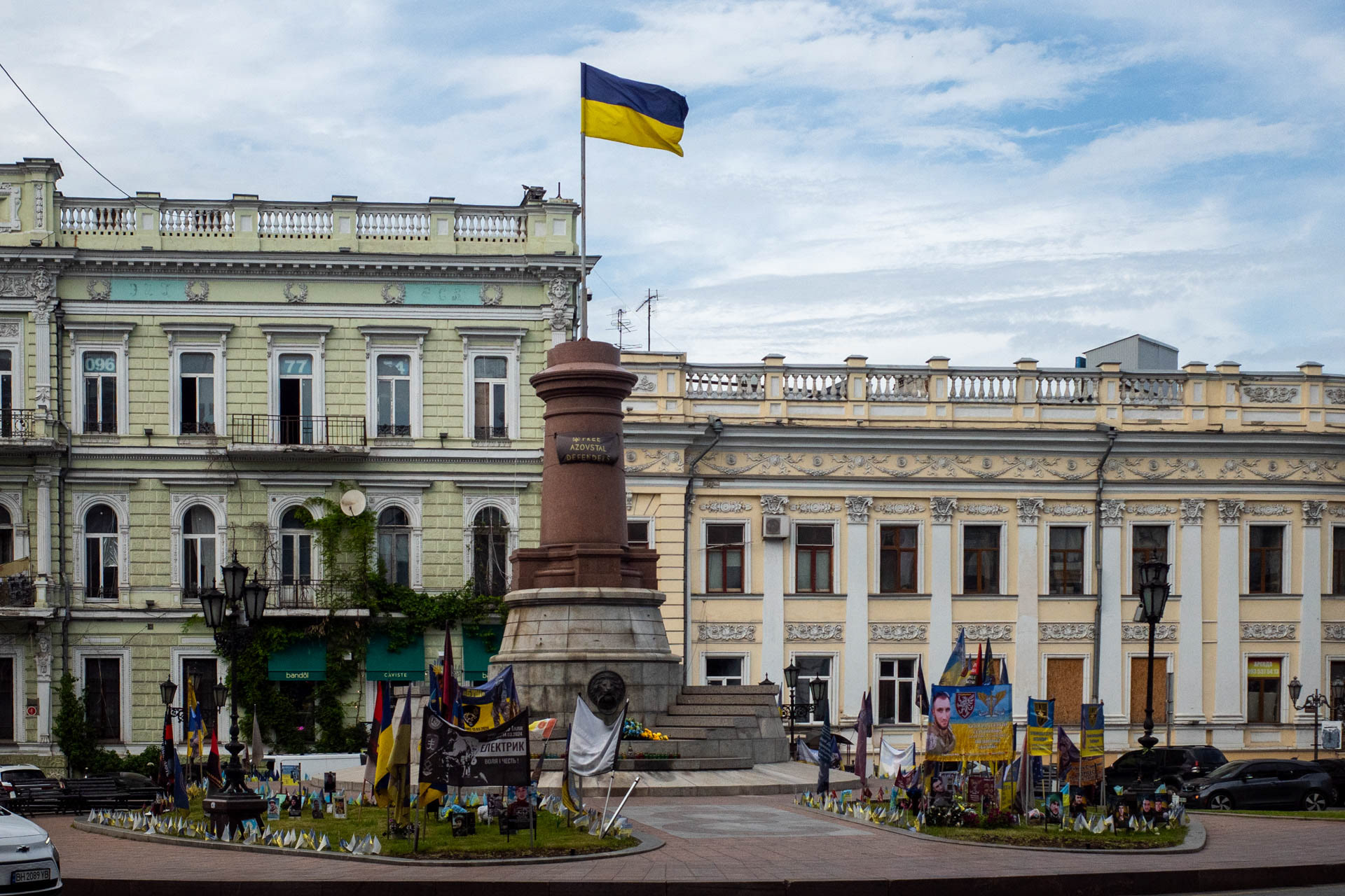 Flags, portraits and tributes honoring fallen Ukrainian soldiers fill a memorial around the pedestal of the former monument to Russian Empress Catherine II on Katerynynska Square in Odesa, Ukraine, on June 12, 2026. The imperial-era statue was dismantled in late 2022 as part of Ukraine's derussification efforts, and the Ukrainian national flag now flies atop the empty pedestal. A plaque on the pedestal reads "Free Azovstal Defenders", referring to the Ukrainian troops who defended the Azovstal steelworks in Mariupol.
