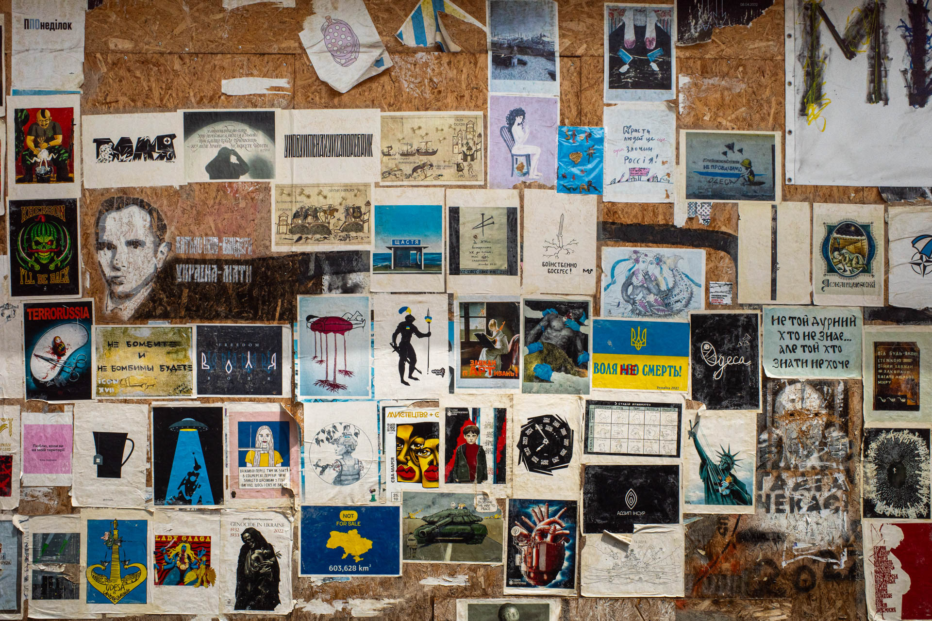 A wall covered with dozens of protest posters, prints and artworks reflecting Russia's invasion of Ukraine is displayed along a pedestrian street in Odesa, Ukraine, on June 13, 2026. The collage includes anti-war slogans, the outline of Ukraine, references to Odesa and a poster reading "Воля не смерть" (Freedom, not death), a play on the Ukrainian motto "Freedom or death".