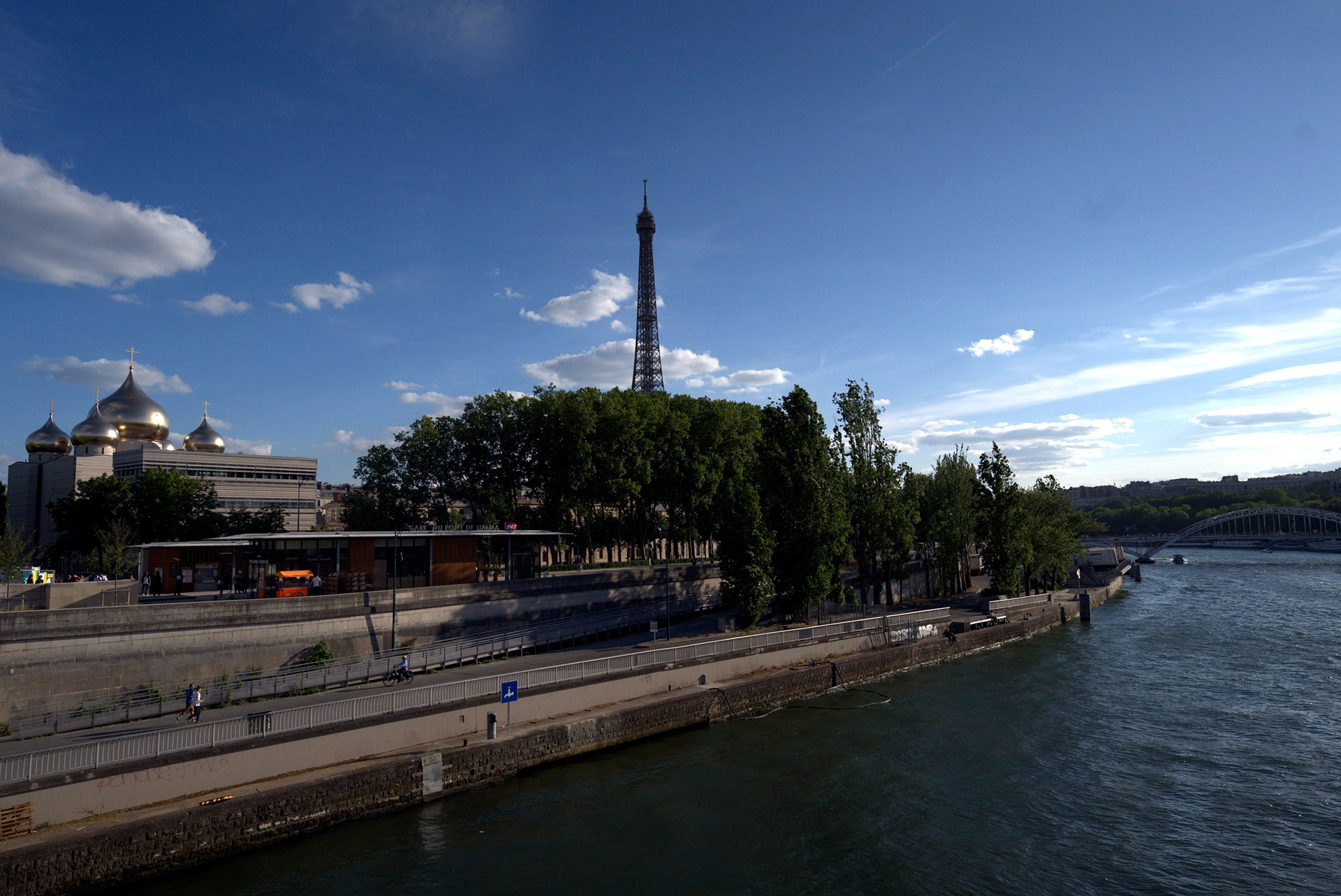 Paris 03: The Eiffel Tower in the distance across the Seine on a bright blue-sky day