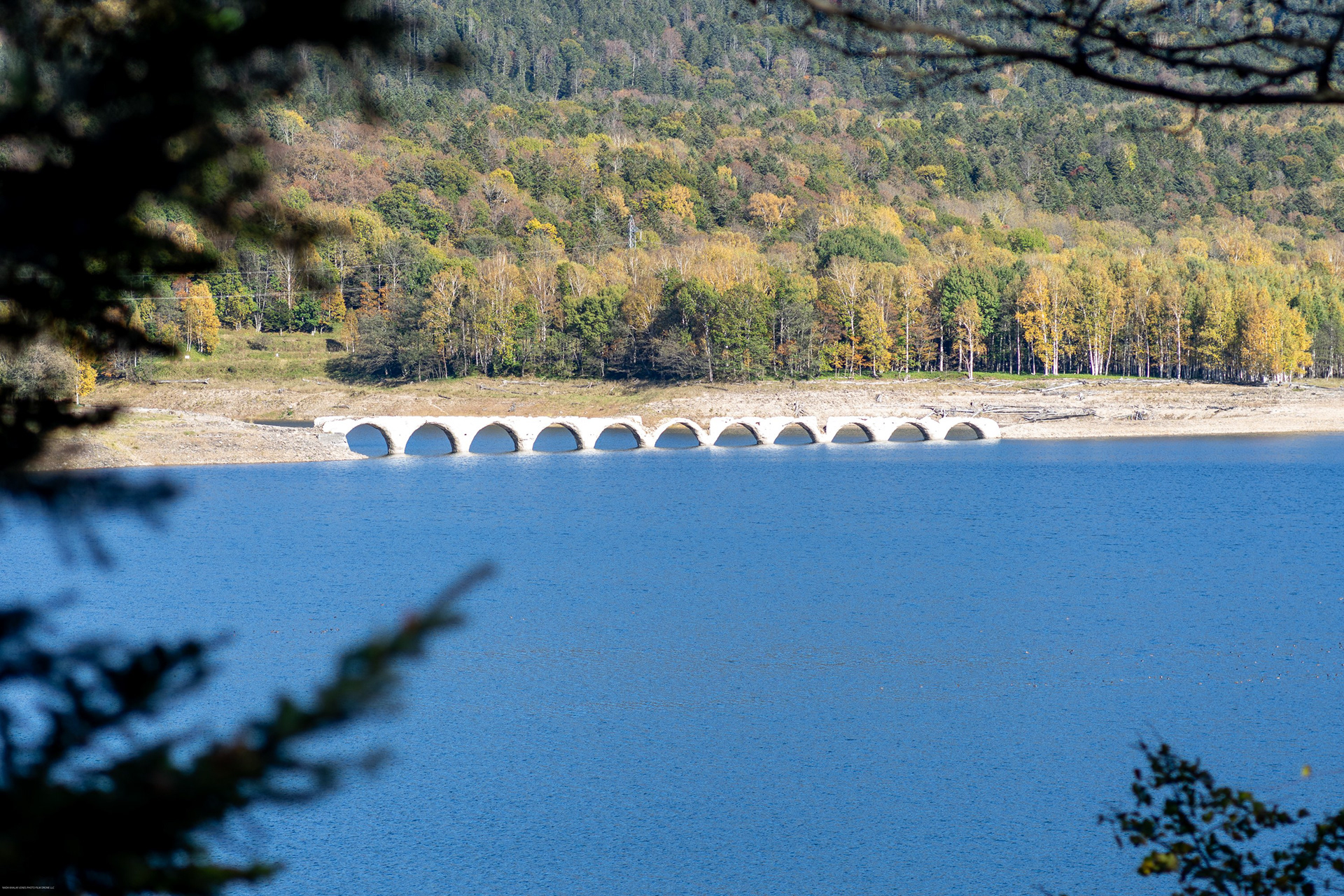 Arch bridge across a blue lake in Hokkaido, Japan