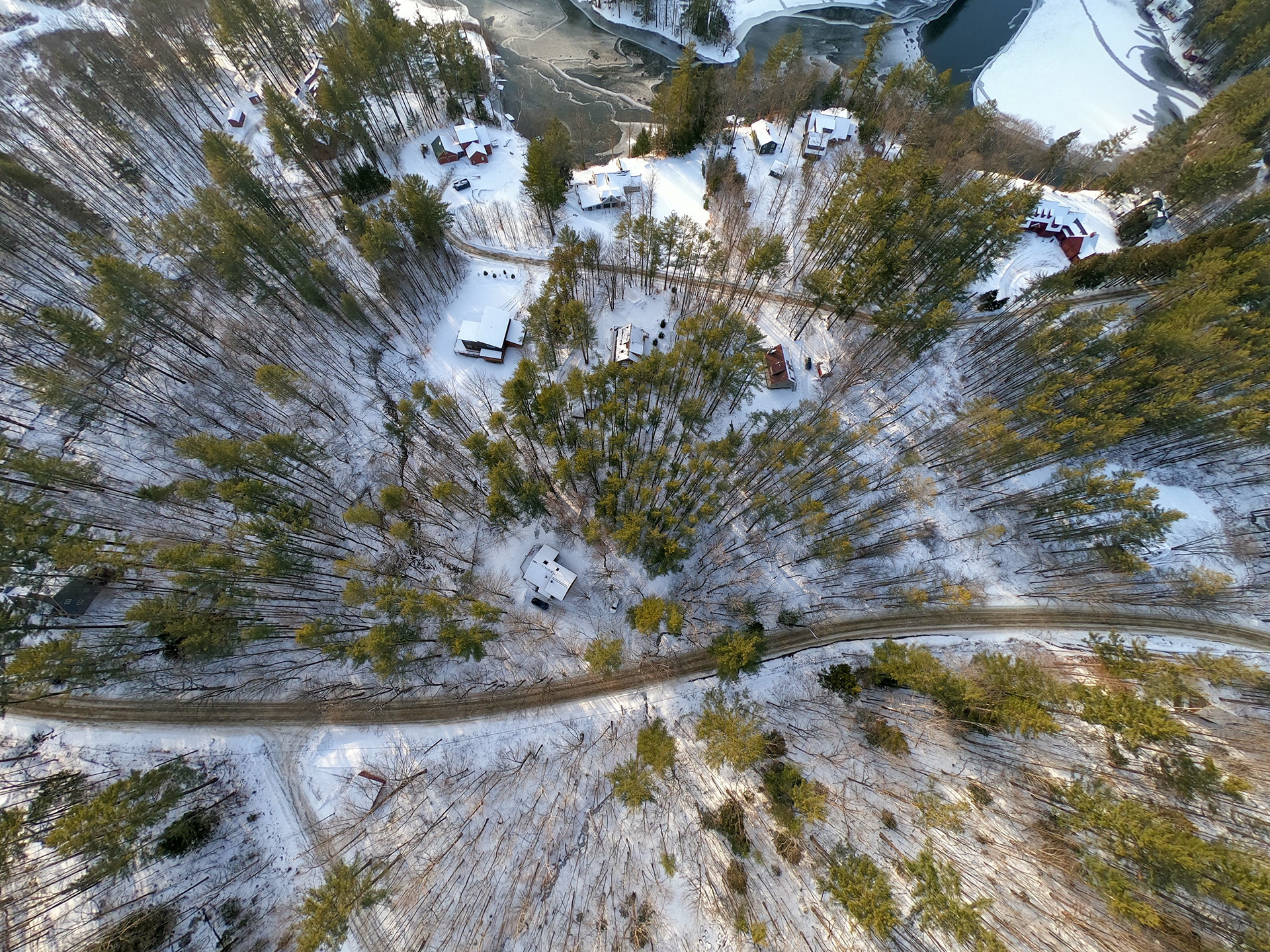 Aerial of a snowy forest and road