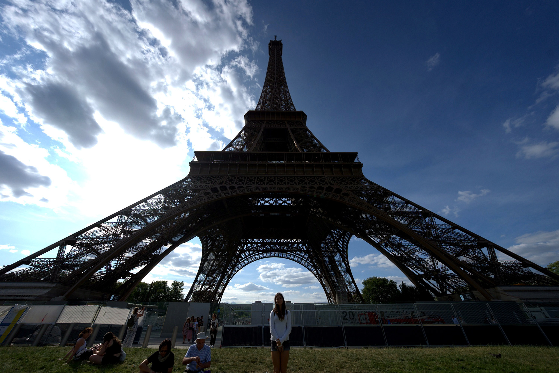 Paris 02: Wide view up at the Eiffel Tower's ironwork arch under dramatic clouds
