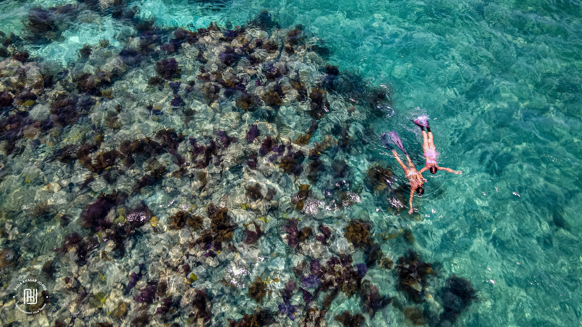 drone photograph girls on coral reef