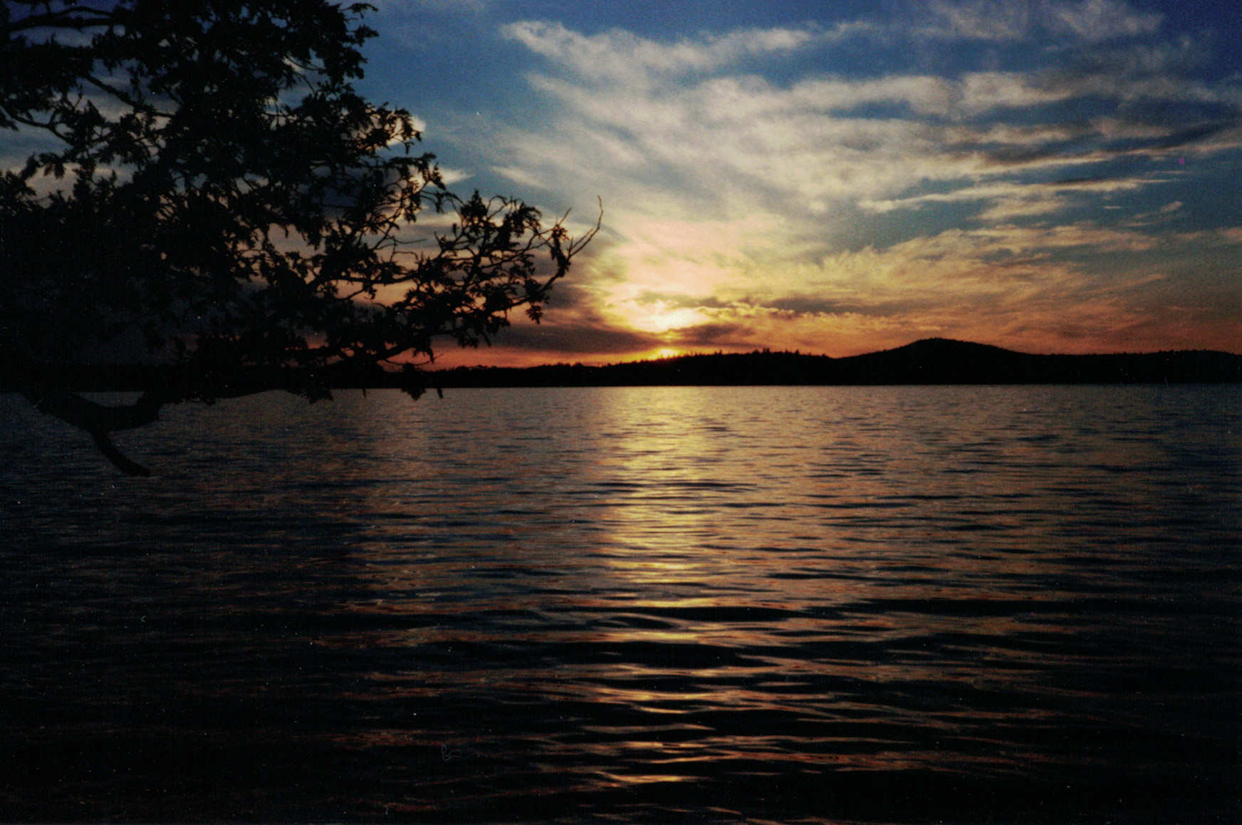 Sunset over Middle Saranac Lake. I took this photo while cycling through the Adirondacks back in May 2000.