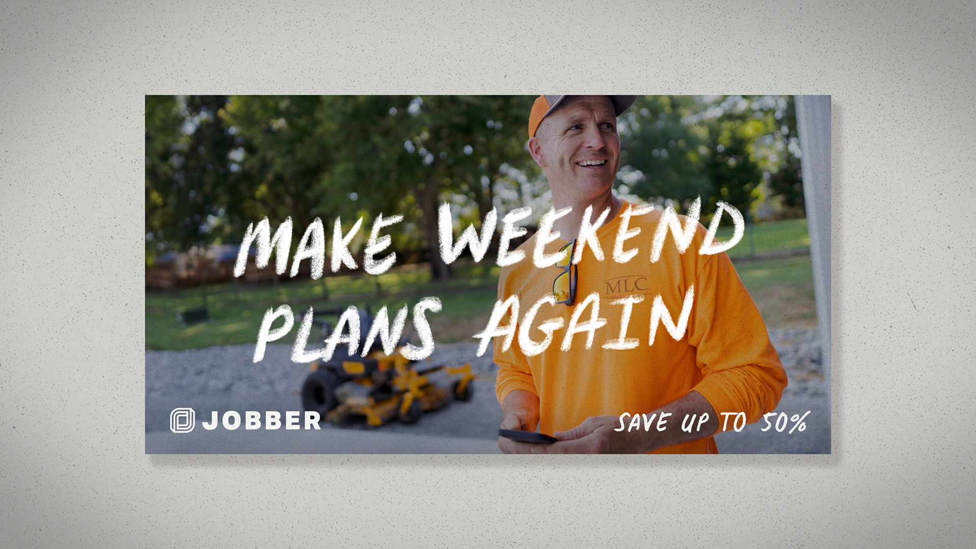 A smiling lawn maintenance worker, holding a smart phone with the tagline "Make weekend plans again" over top. Jobber log and "save up to 50%" along the bottom.